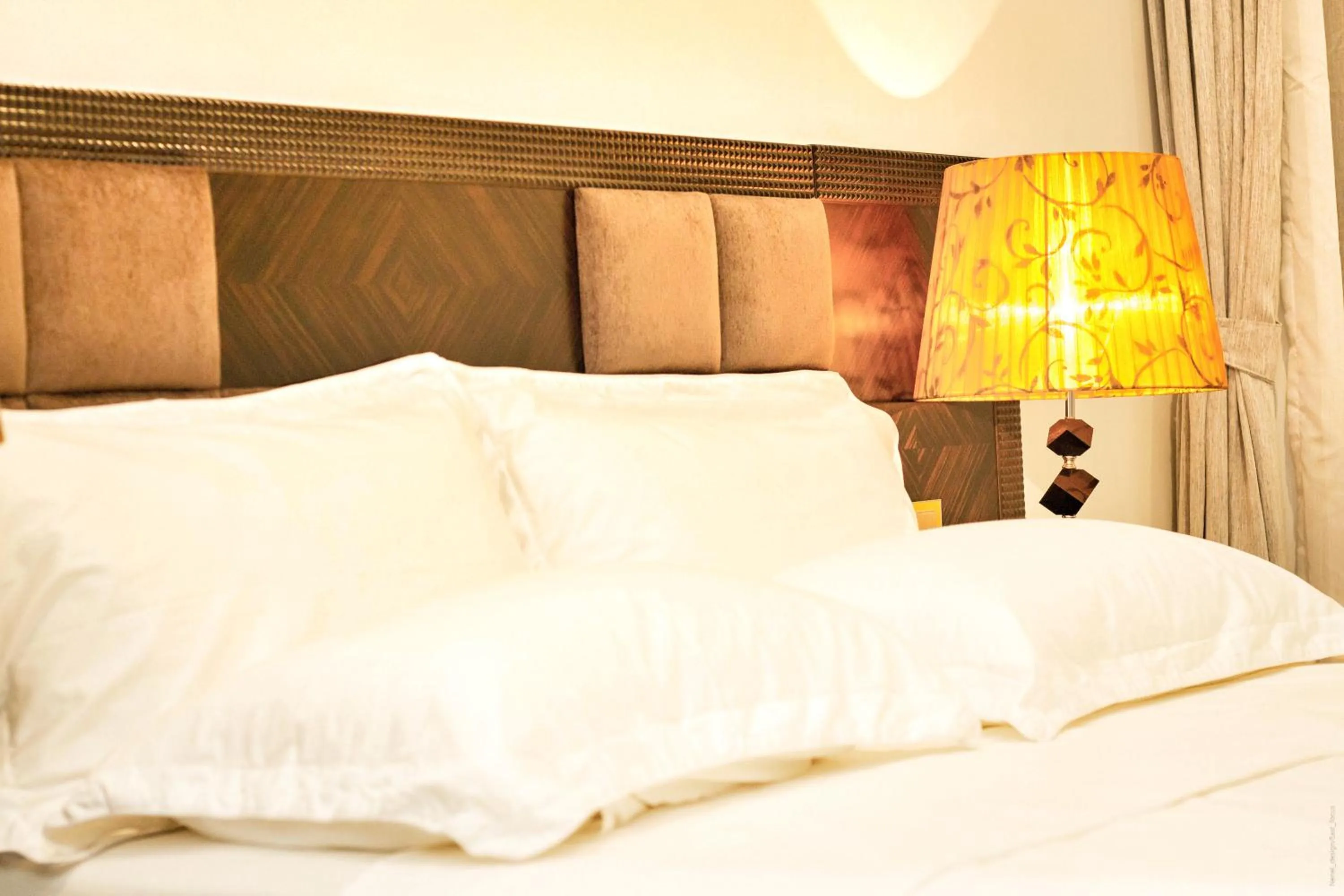 Bed in The Streamliner Hotel Apartment