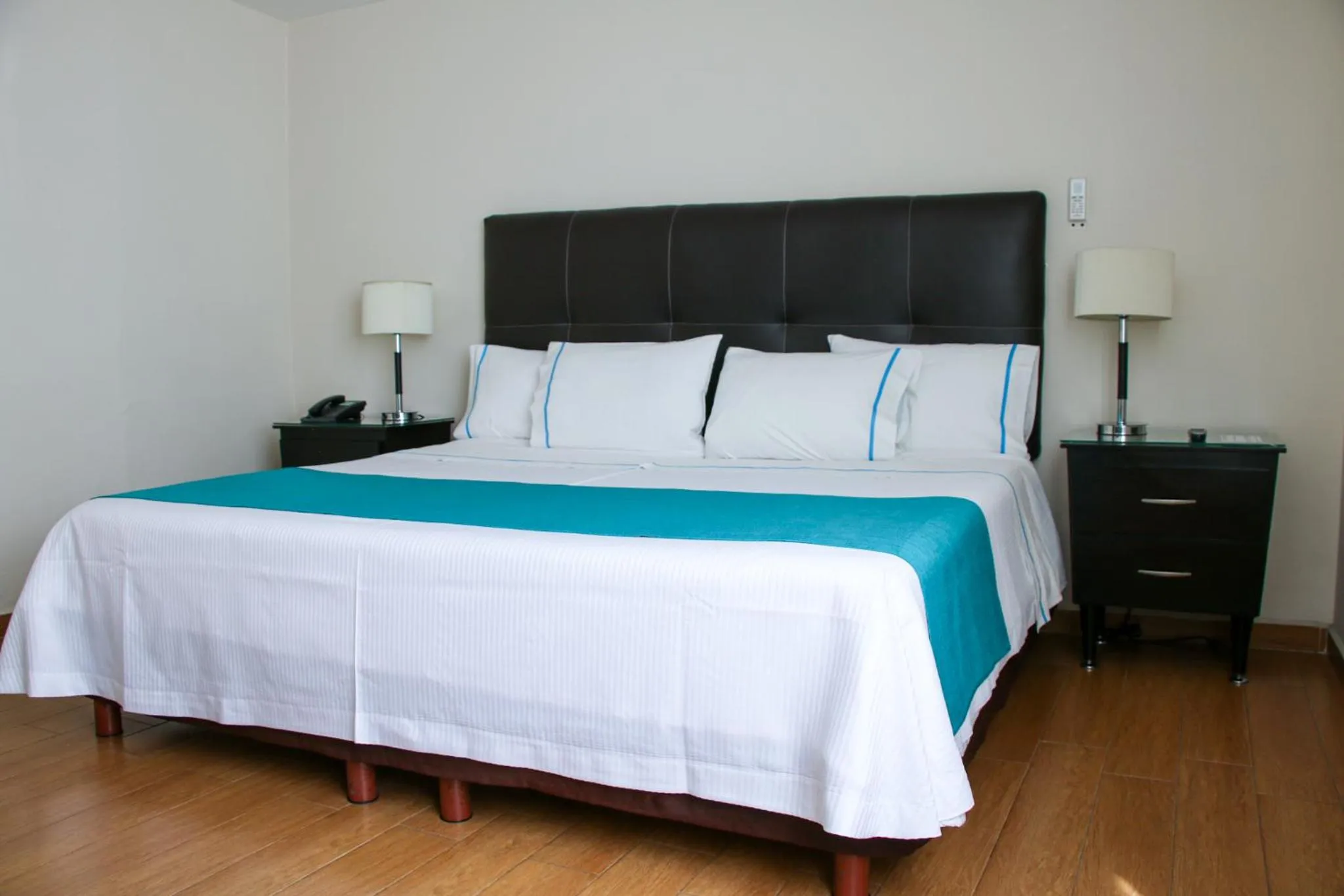 Bed in Country Hotel & Suites