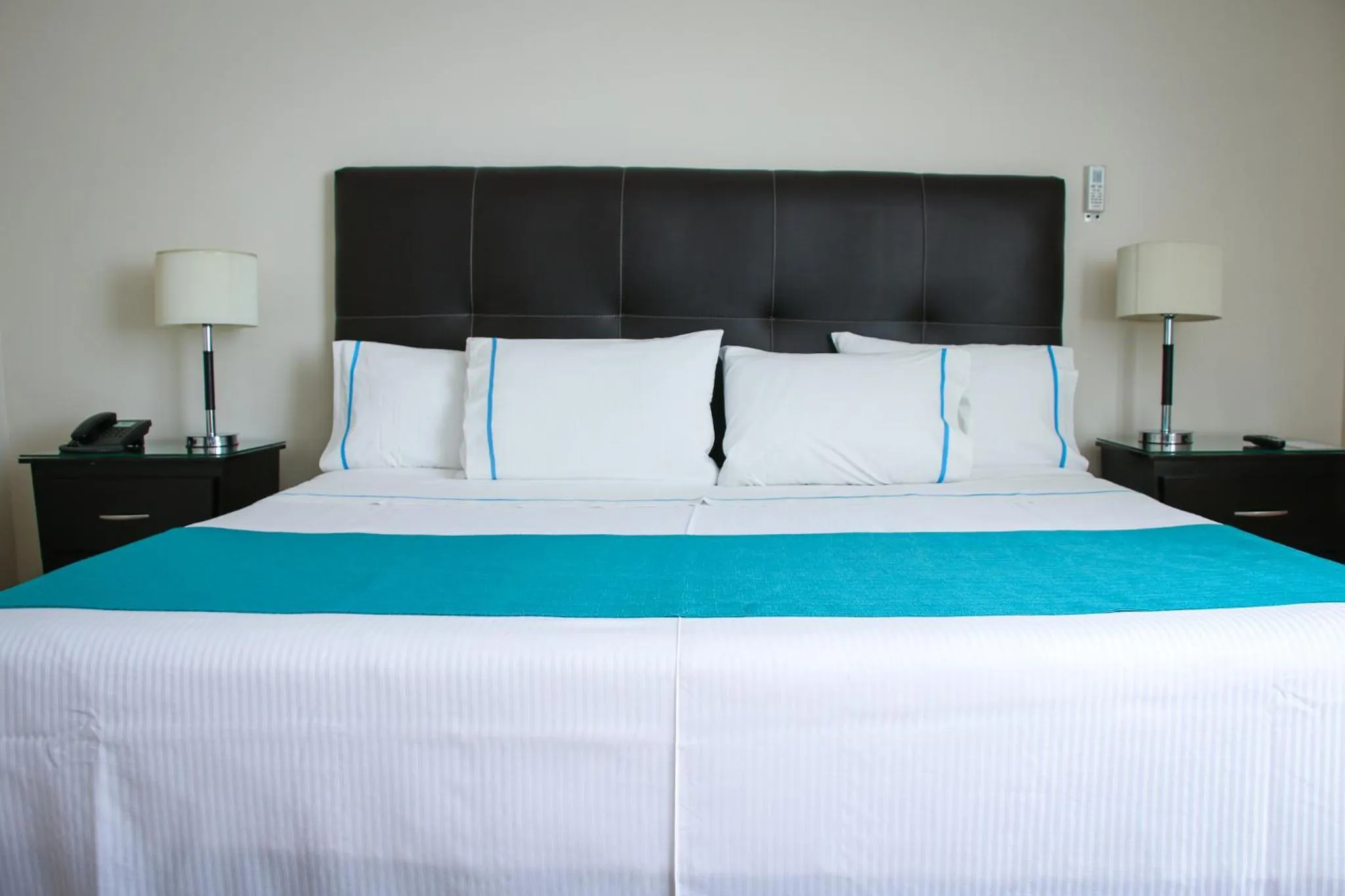 Bed in Country Hotel & Suites