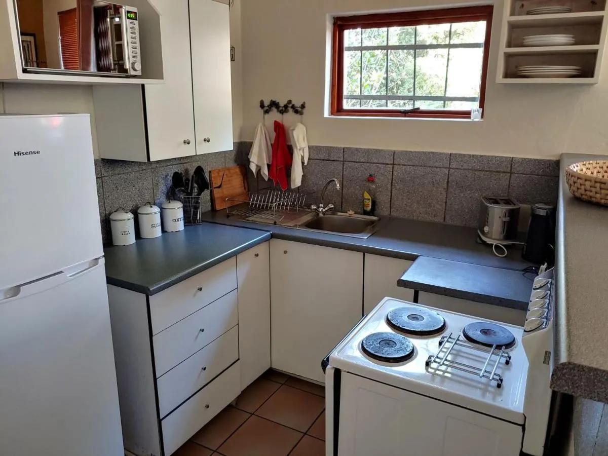 Kitchen or kitchenette in Moonflower Cottages