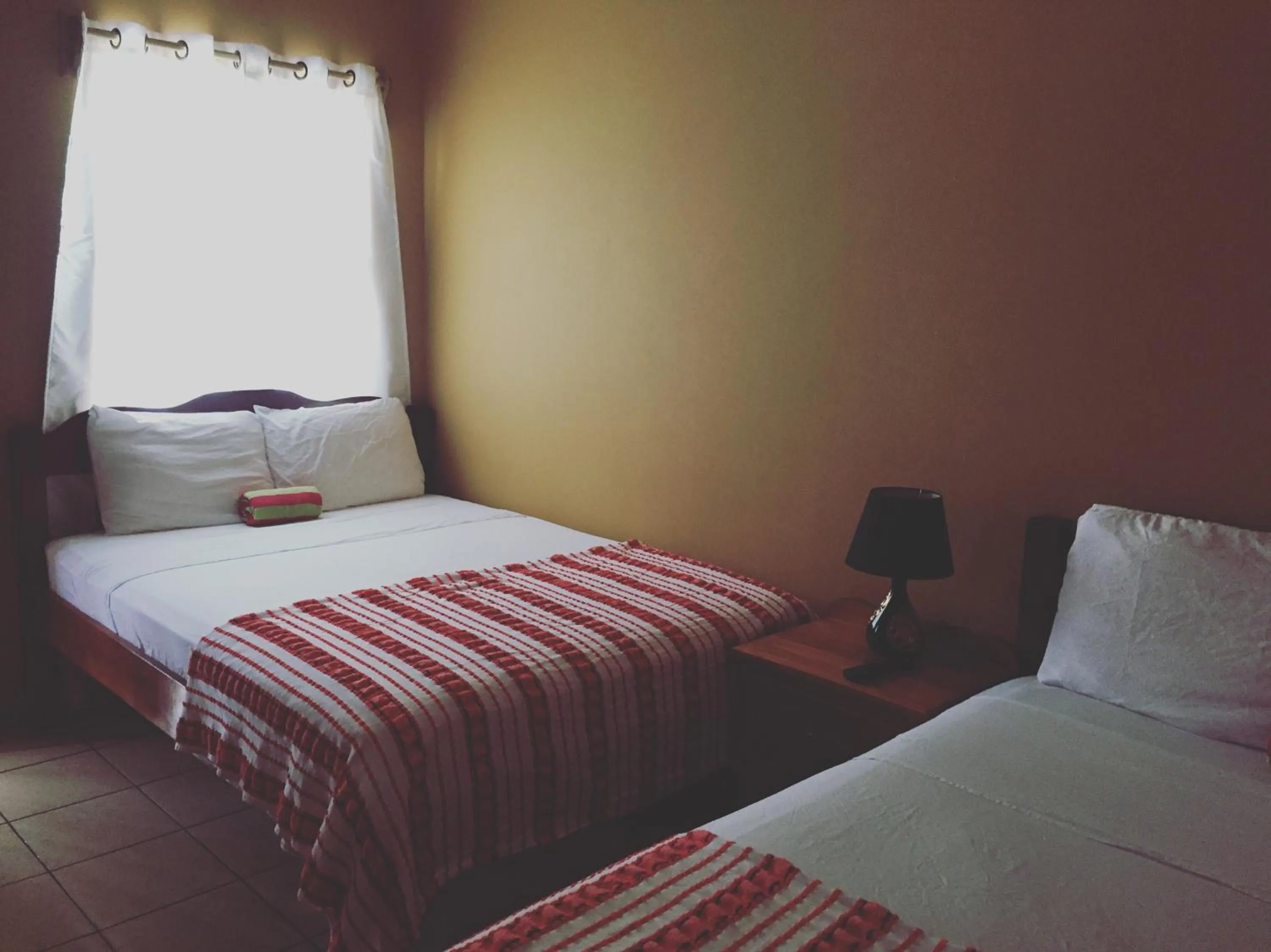 Bed in Ambergris Sunset Hotel