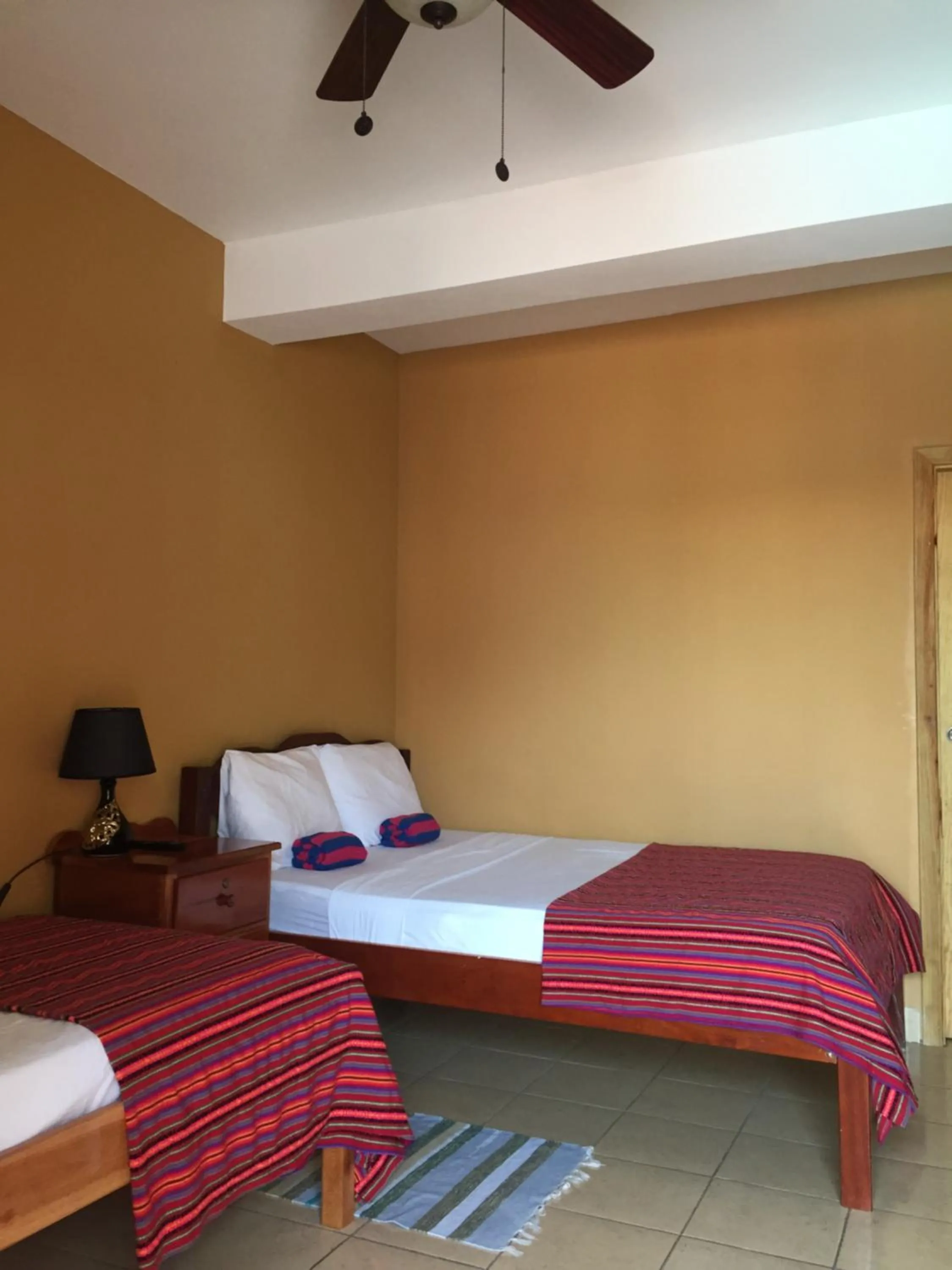 Bed in Ambergris Sunset Hotel