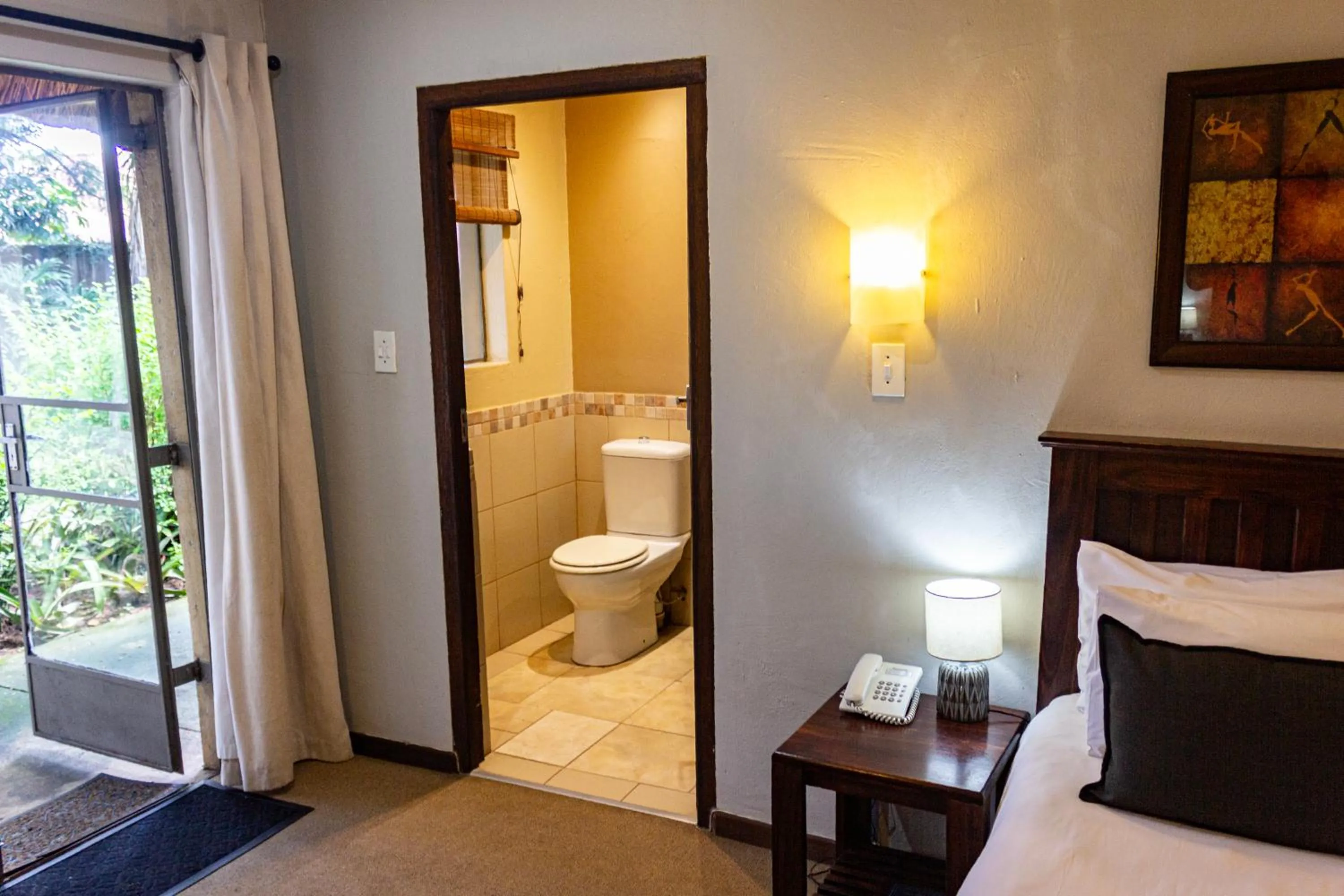 Toilet, Bed in Hotel Numbi & Garden Suites