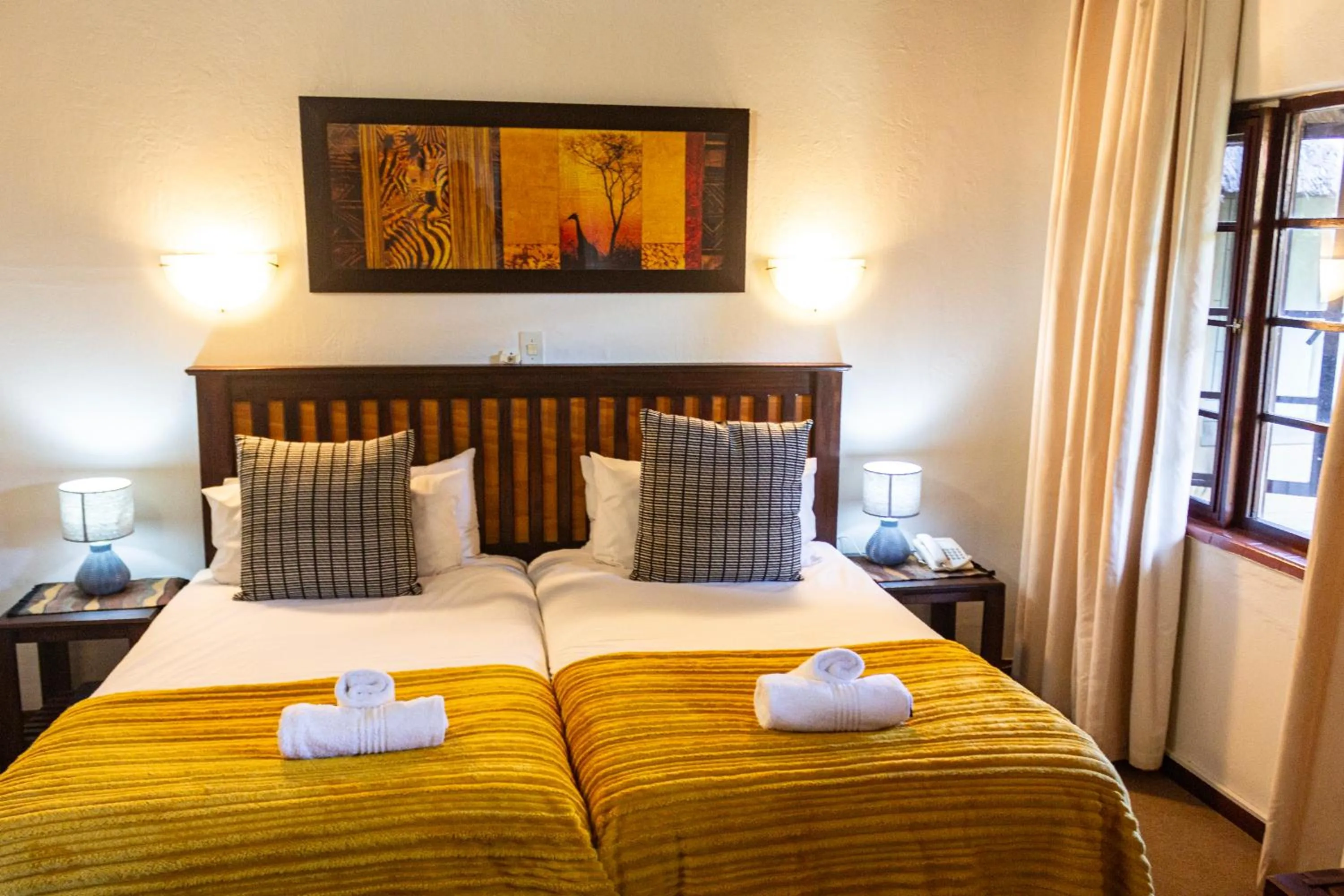 Bed in Hotel Numbi & Garden Suites