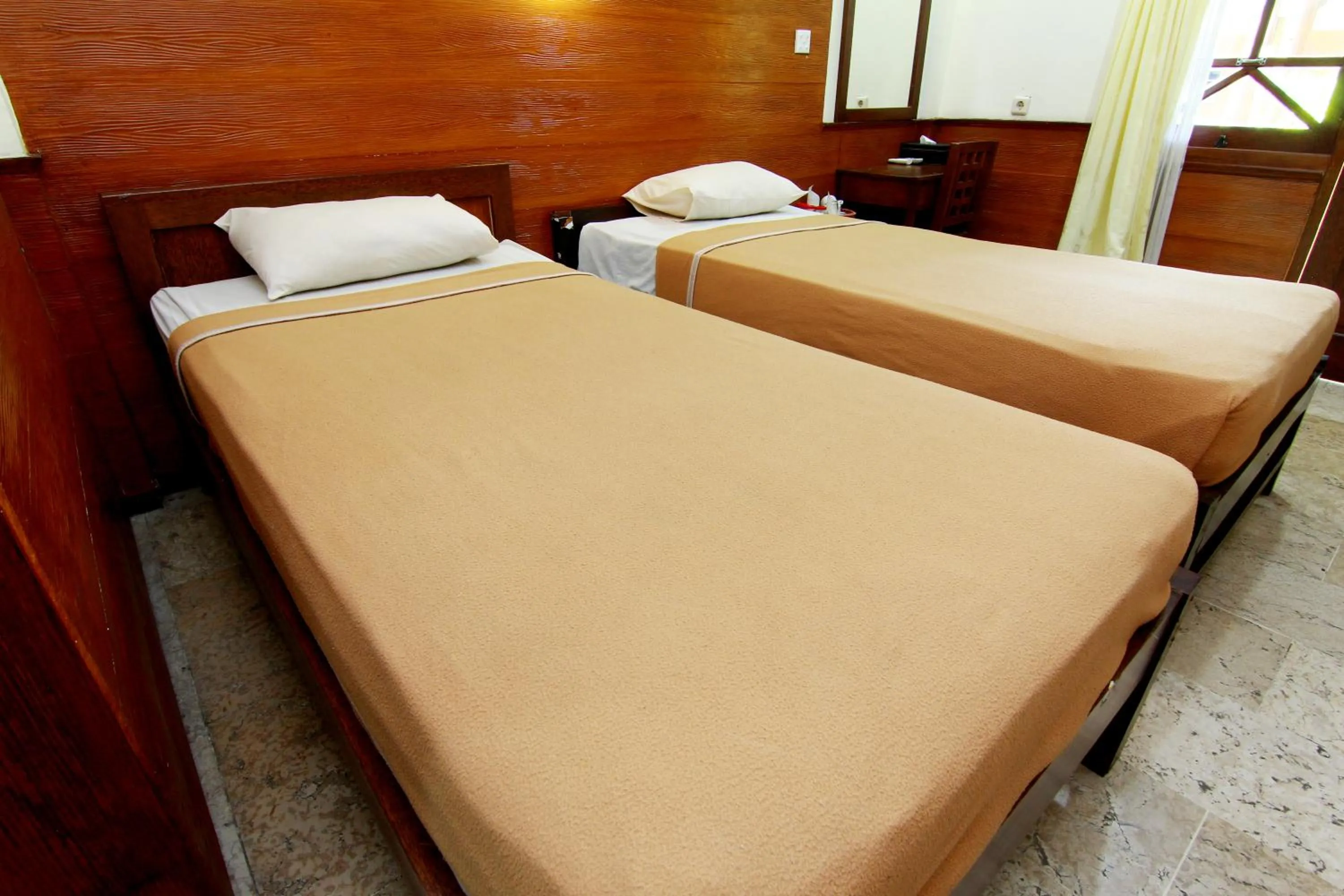 Bed in The Soemarsono Hotel