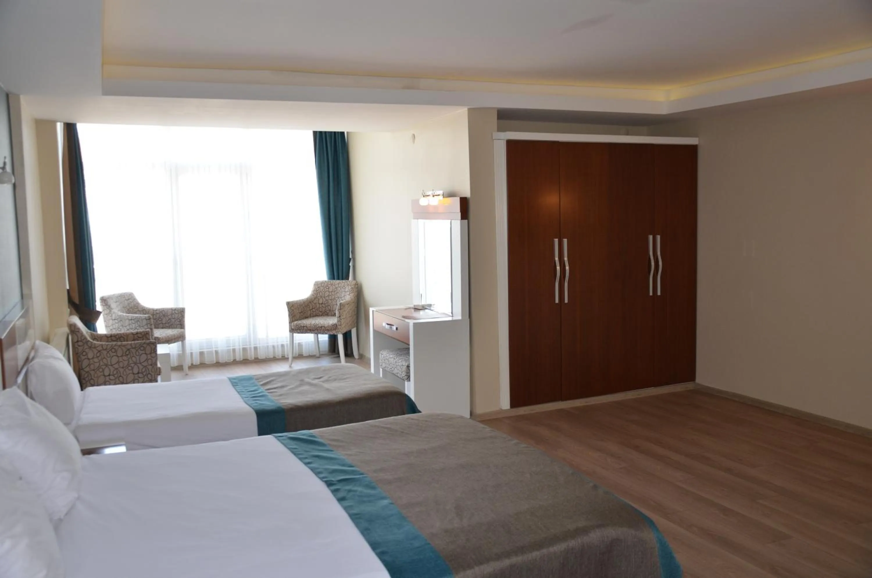 Living room, Bed in Grand Ahos Hotel