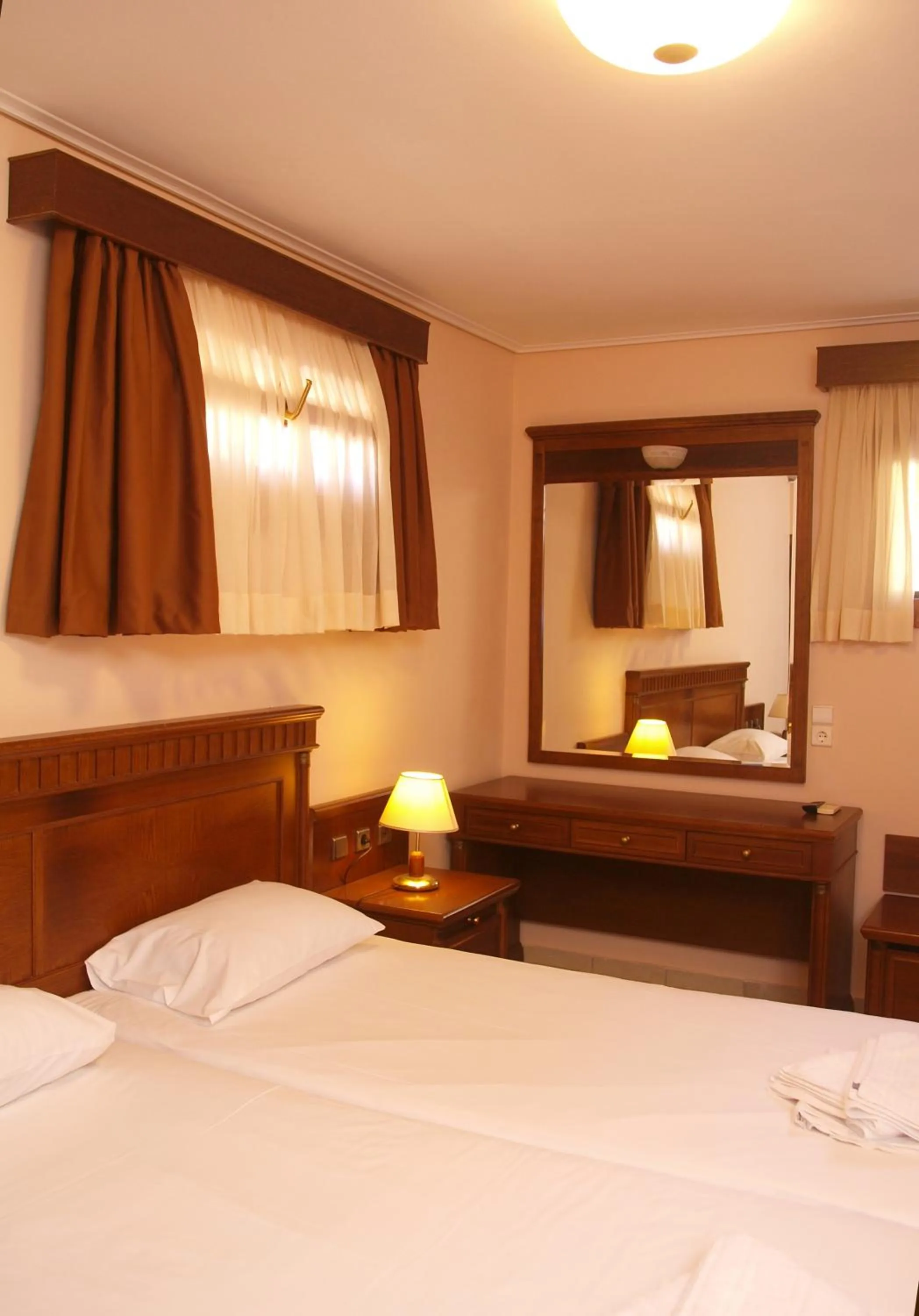 Bed in Mylos Hotel Apartments