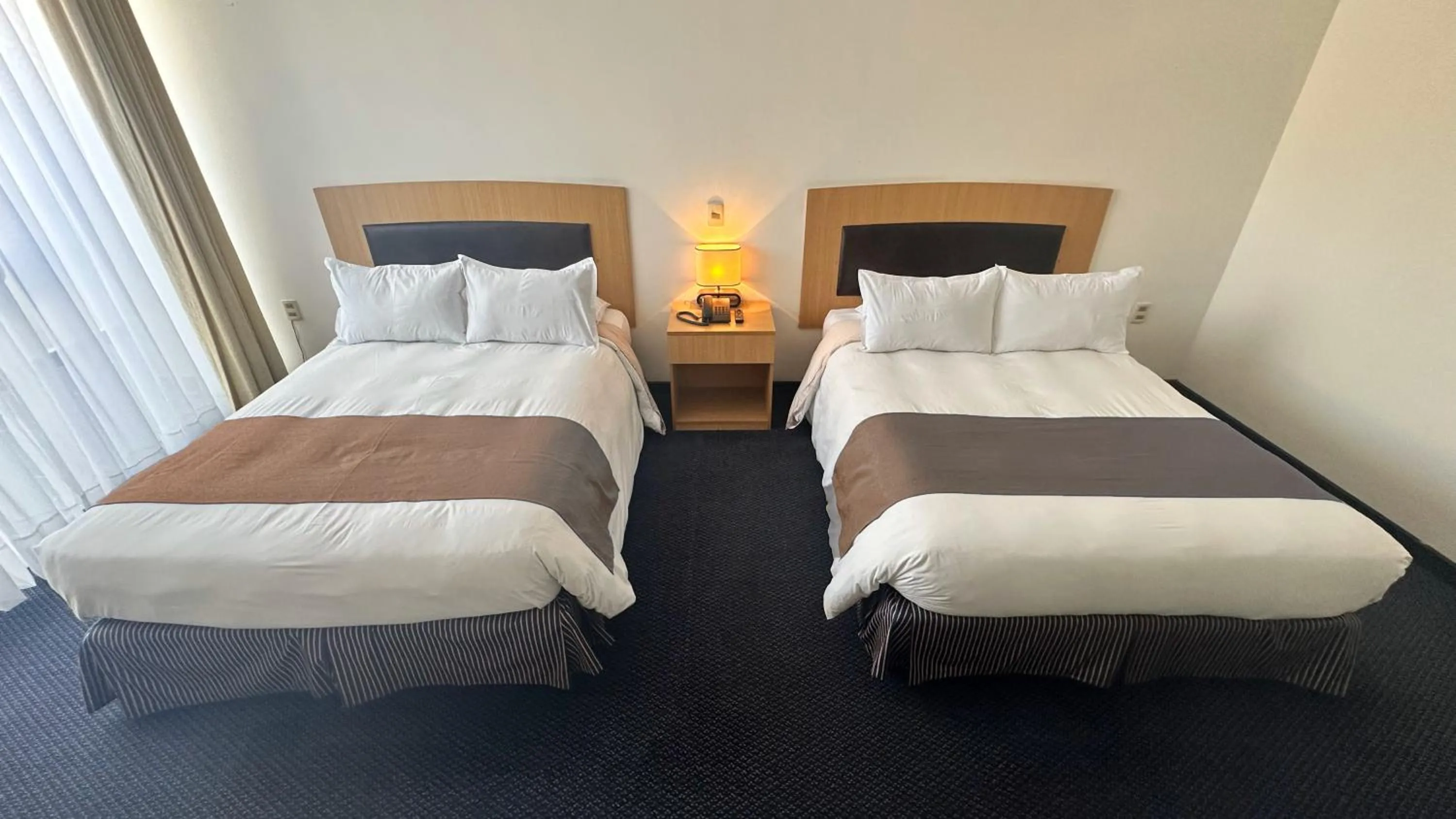 Bed in Delfines Apart Hotel