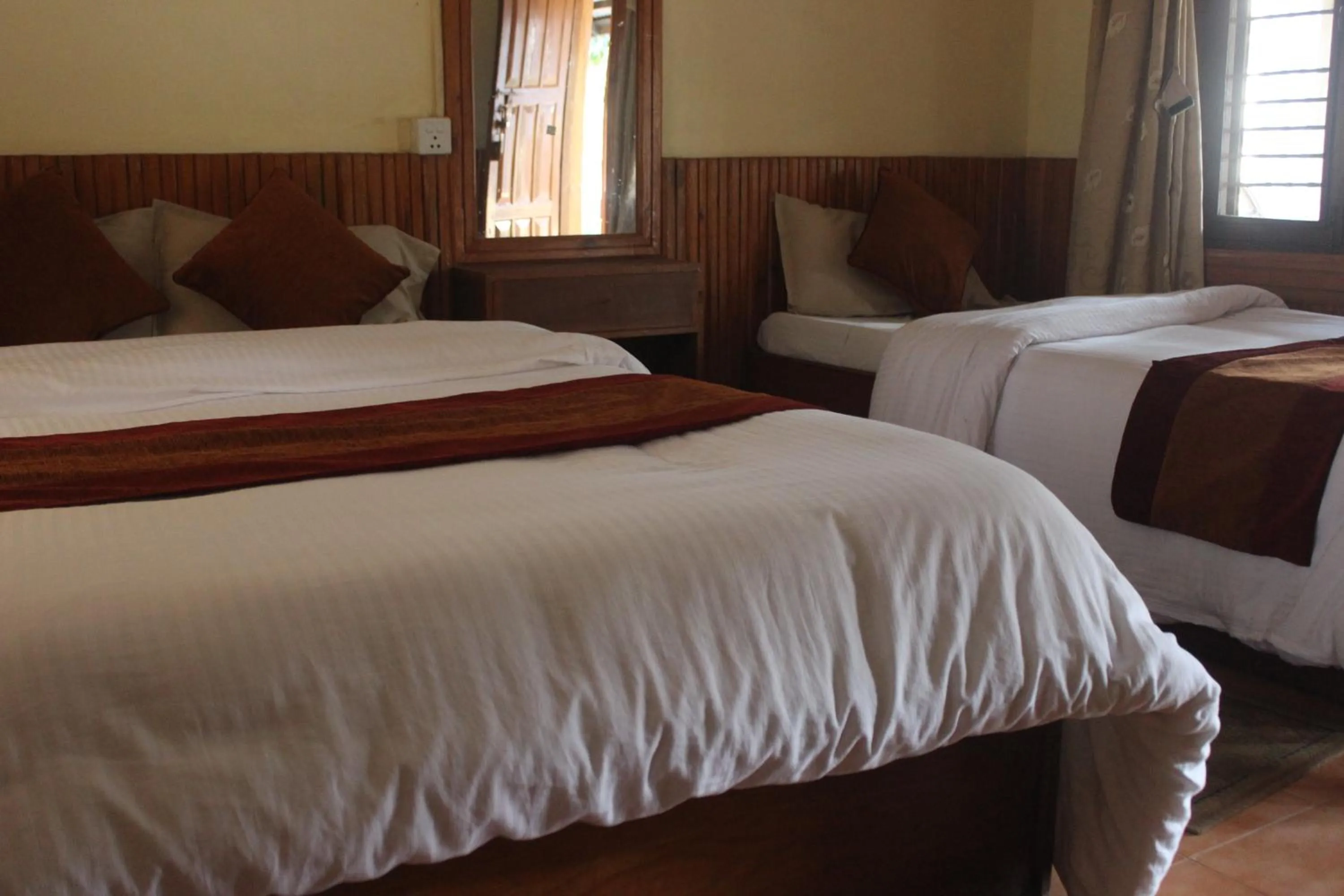 Bed in Chitwan Forest Resort with swimming pool , Chitwan National Park