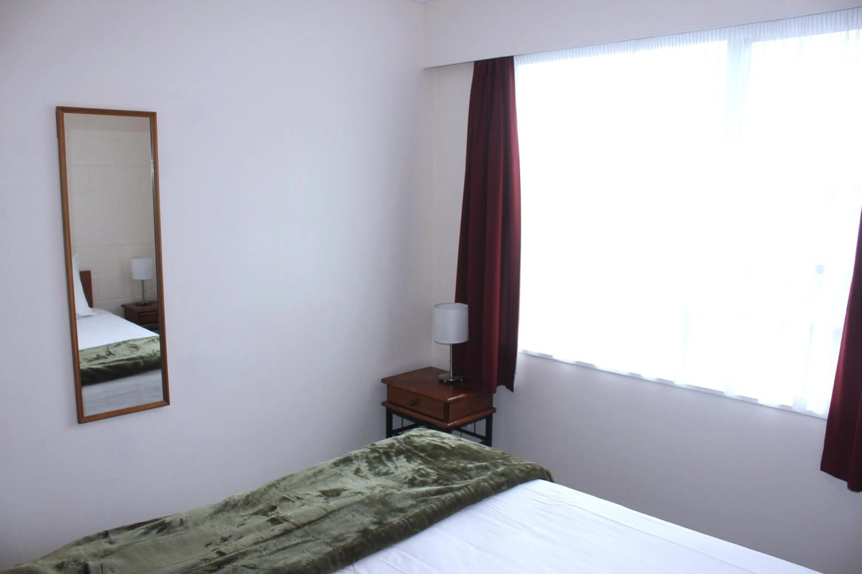 Bed in Kapiti Gateway Motel