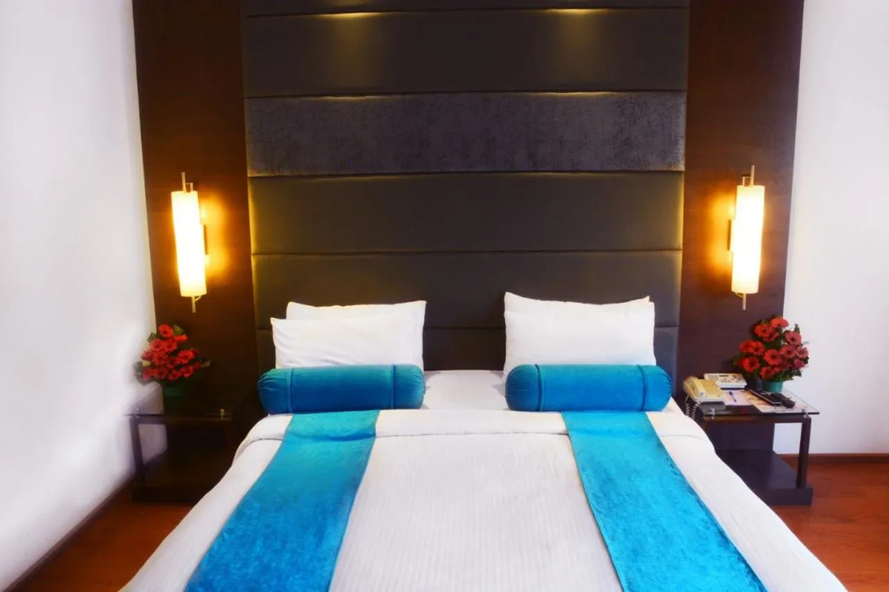 Bed in Ashraya International Hotel