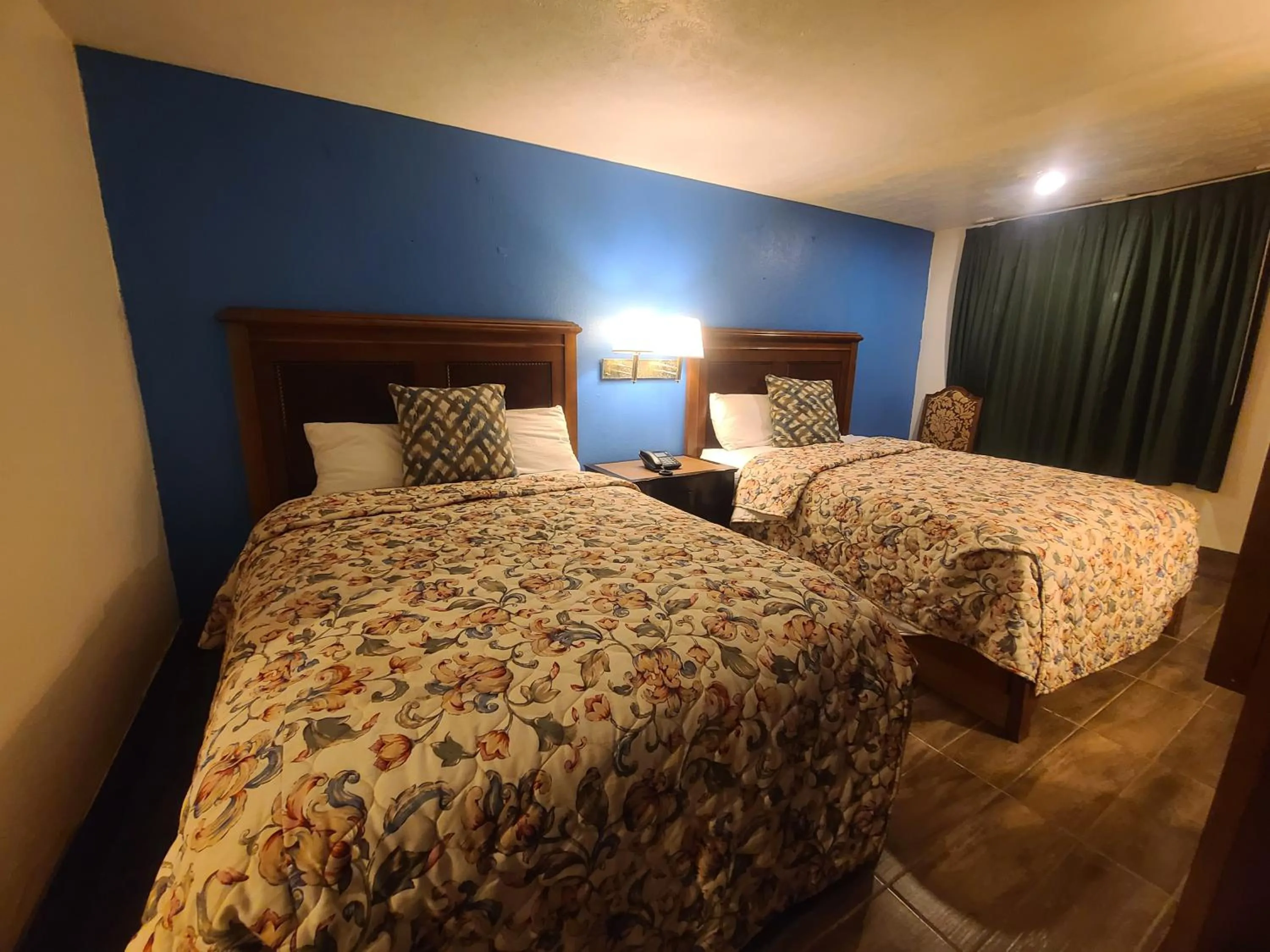 Bed in Garden Inn and Extended Stay