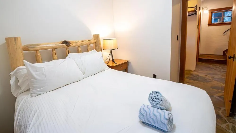 Bed in Snow Creek Cabins by Fernie Lodging Co