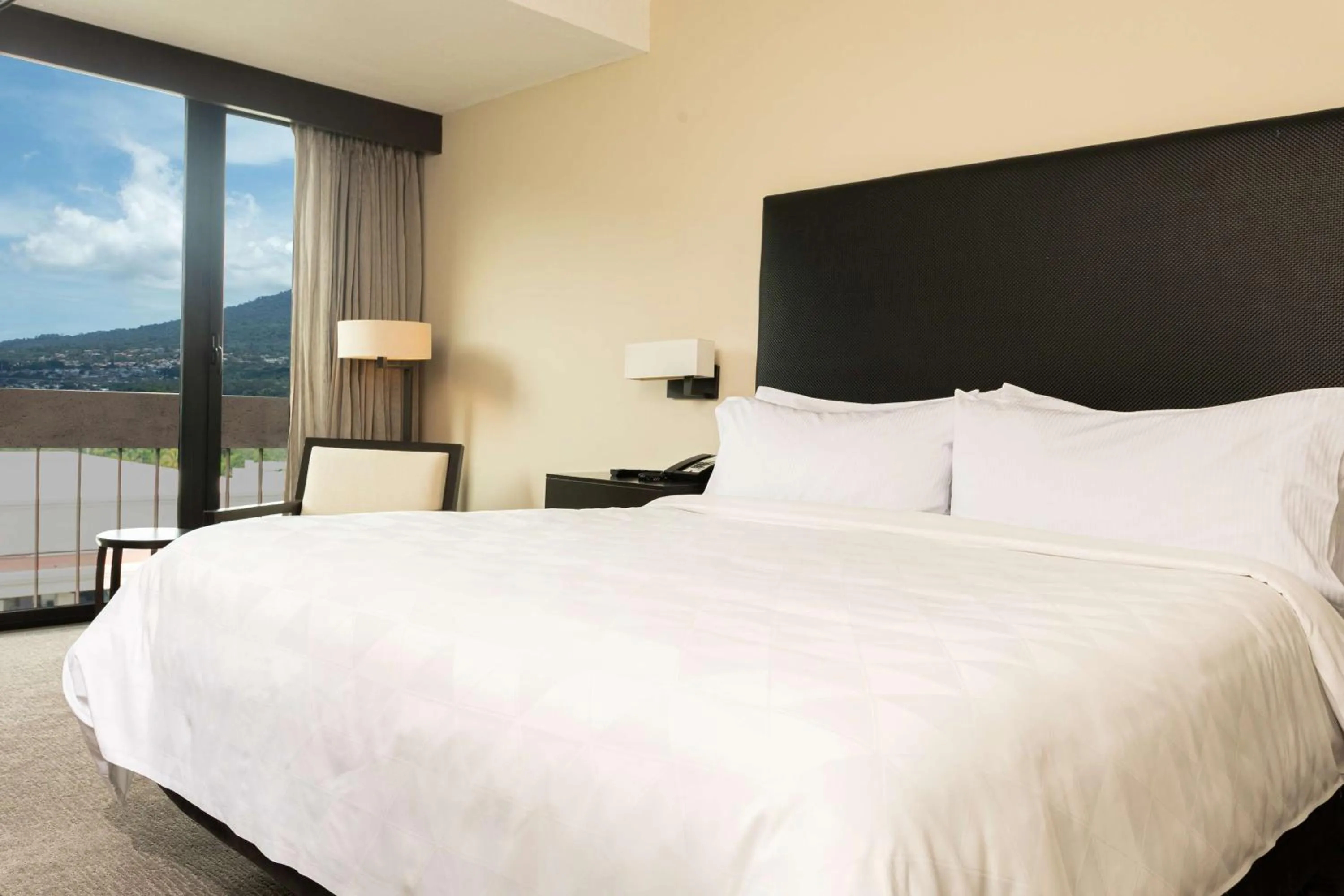 Bed in Crowne Plaza San Salvador, an IHG Hotel