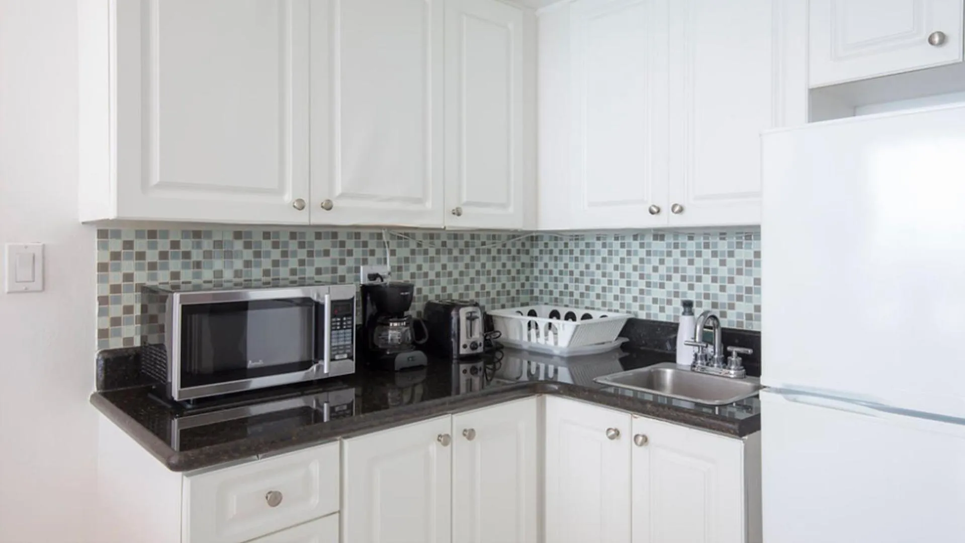 Kitchen or kitchenette in New Point Miami Beach Apartments