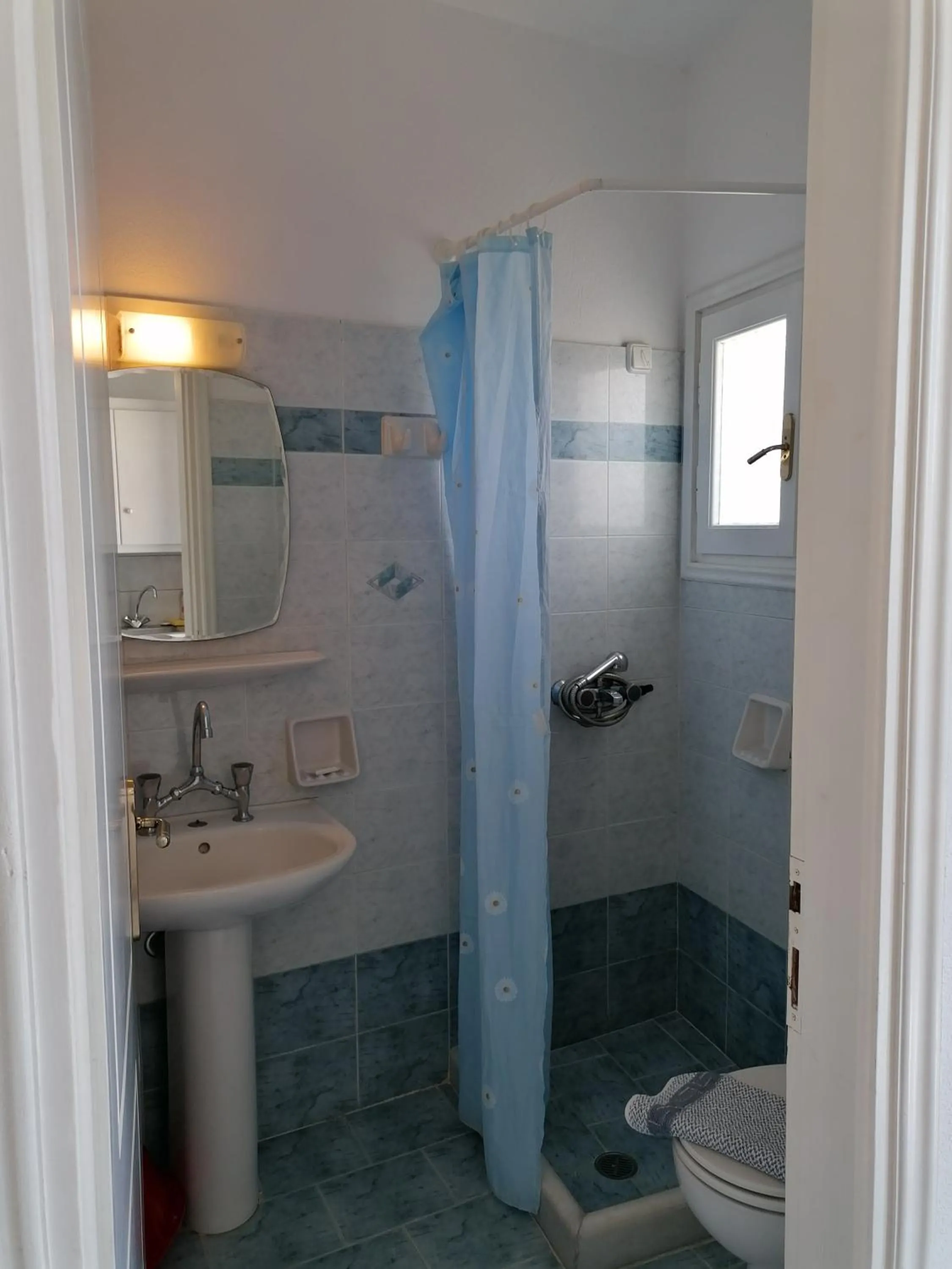Bathroom in Flora Apartments & Studios