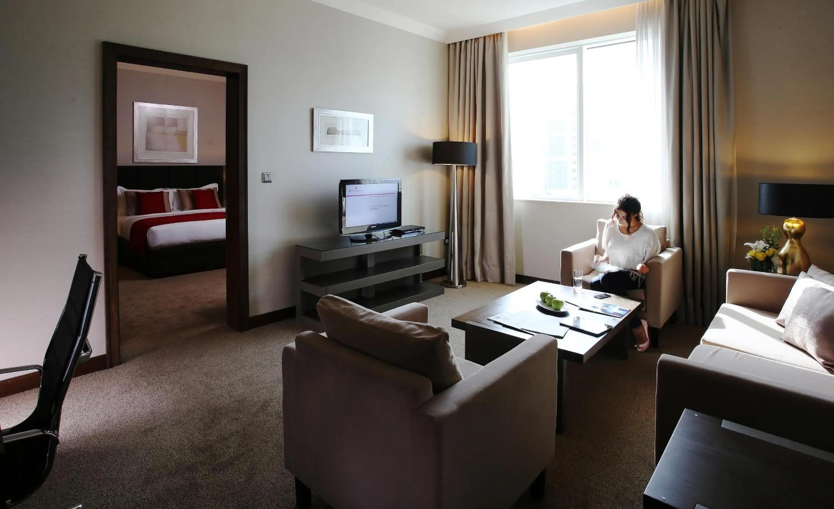 Living room, Bed in Ramada Downtown Abu Dhabi