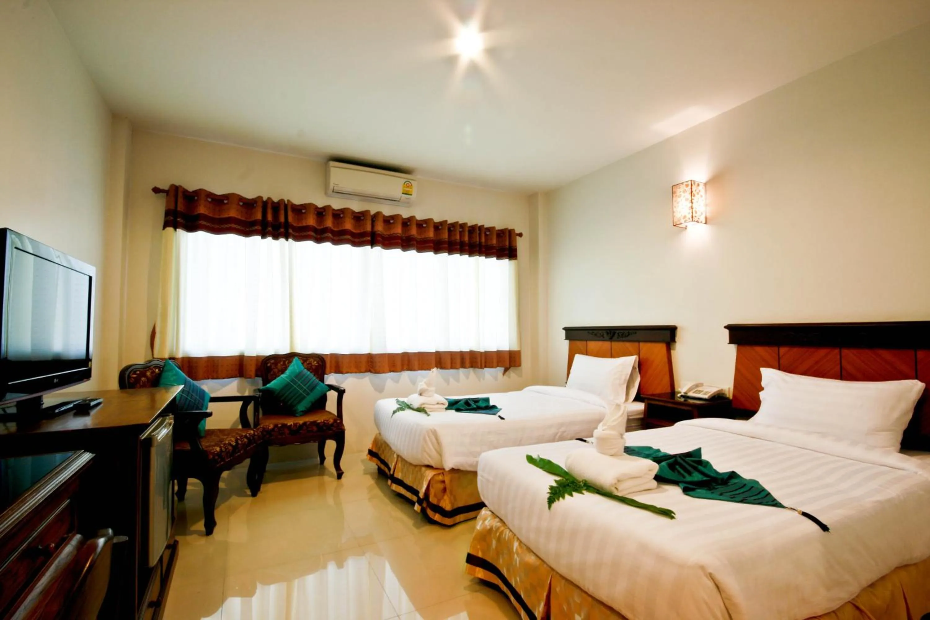 Bed in Chiangrai Grand Room Hotel