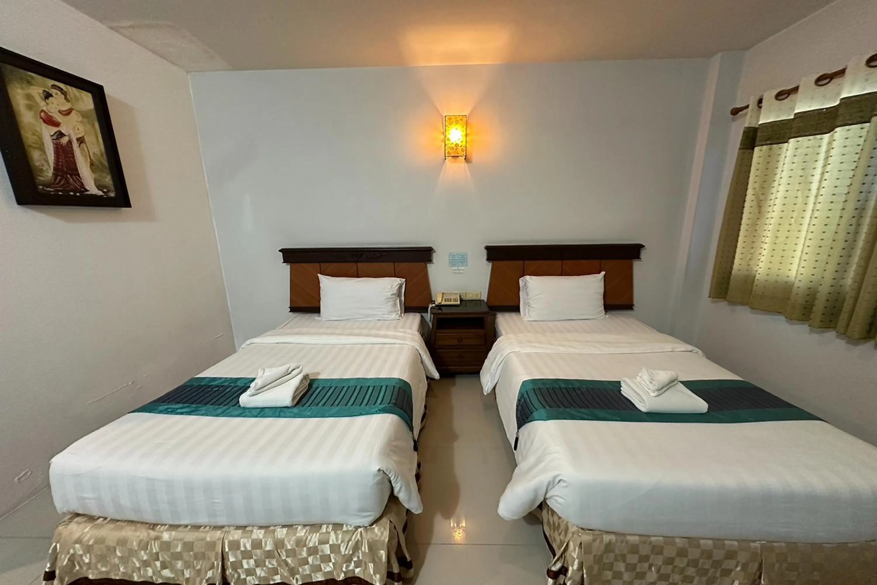 Bed in Chiangrai Grand Room Hotel