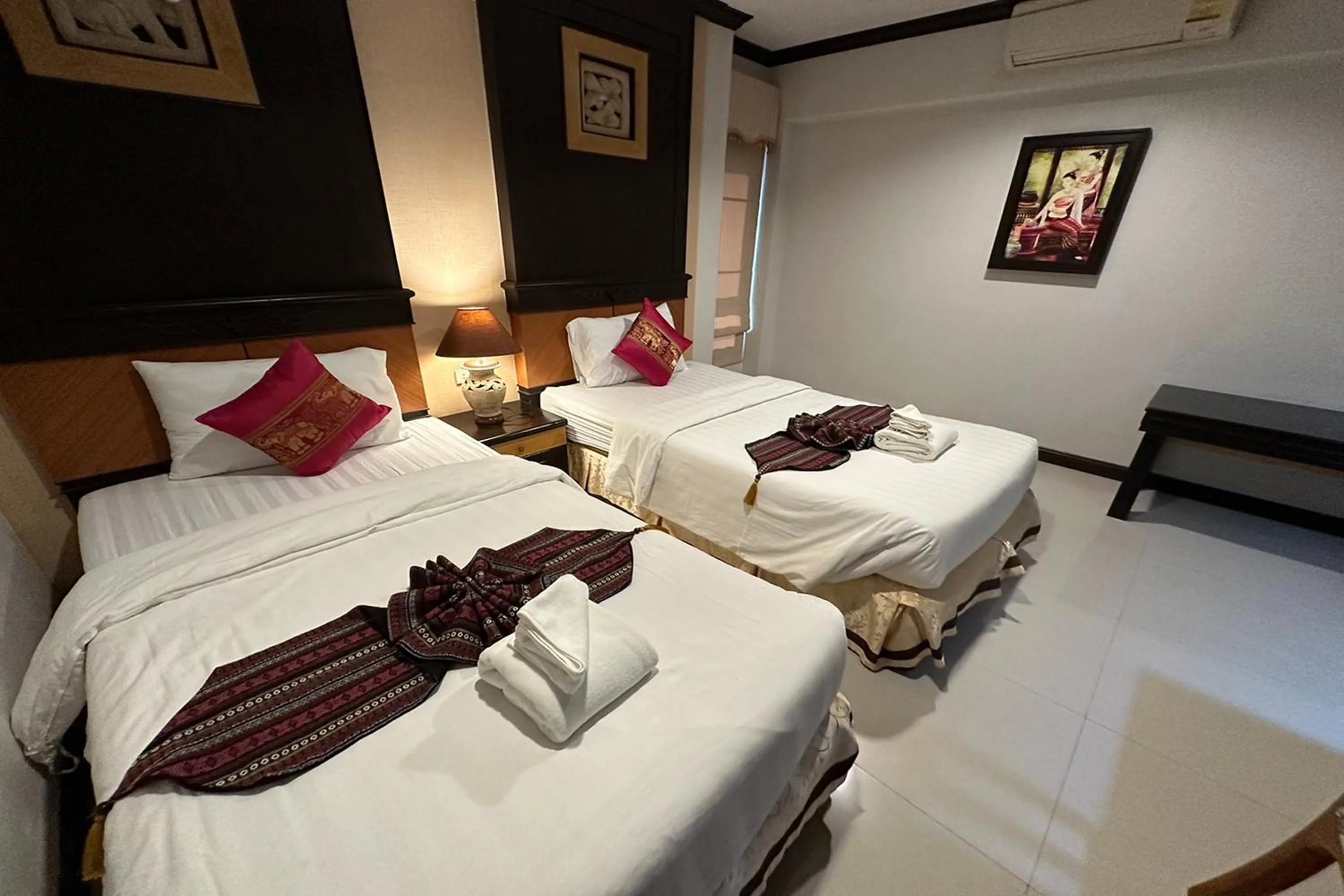 Bed in Chiangrai Grand Room Hotel