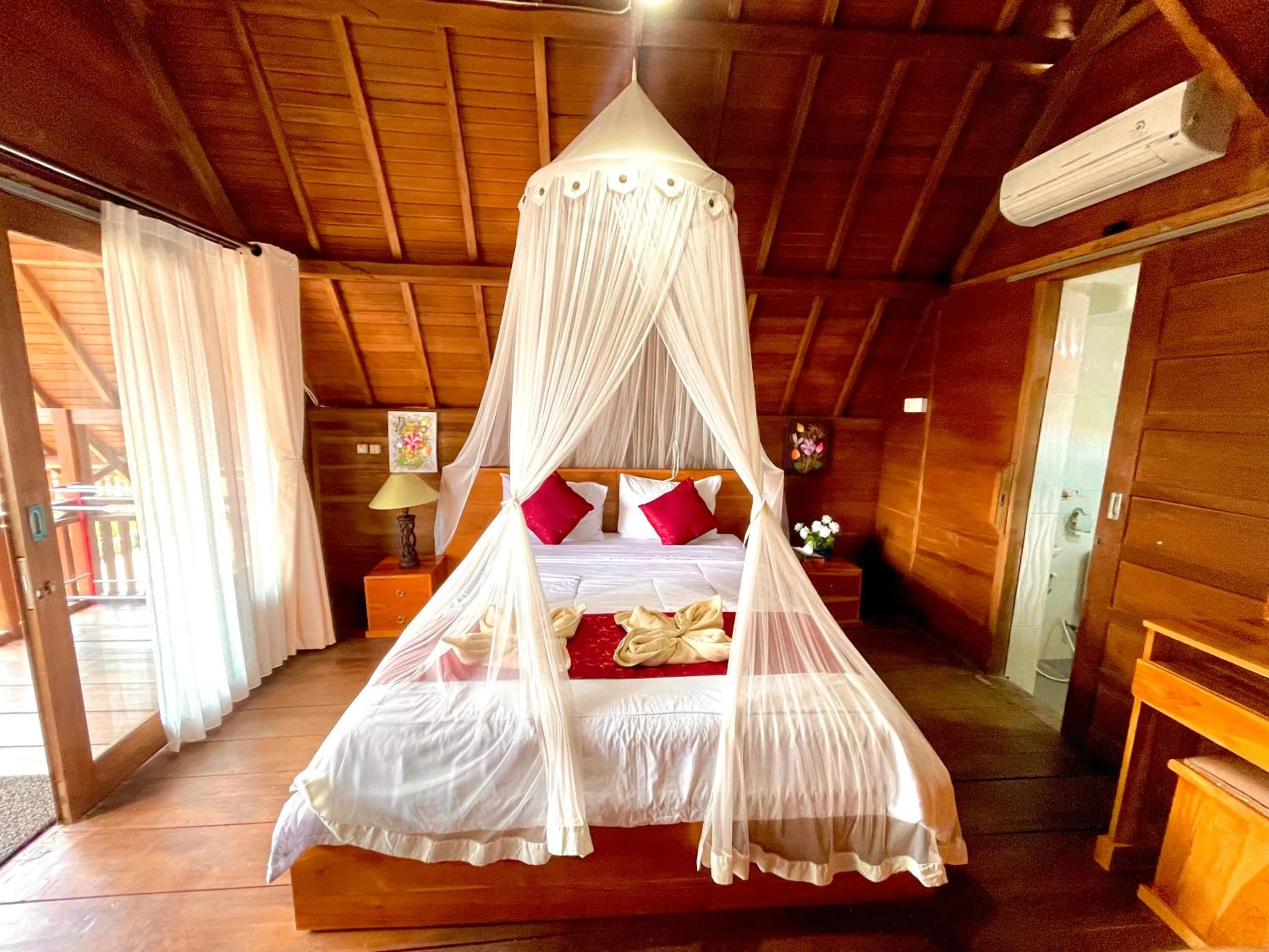 Bed in Ayu Laba Beach Villa and Resto