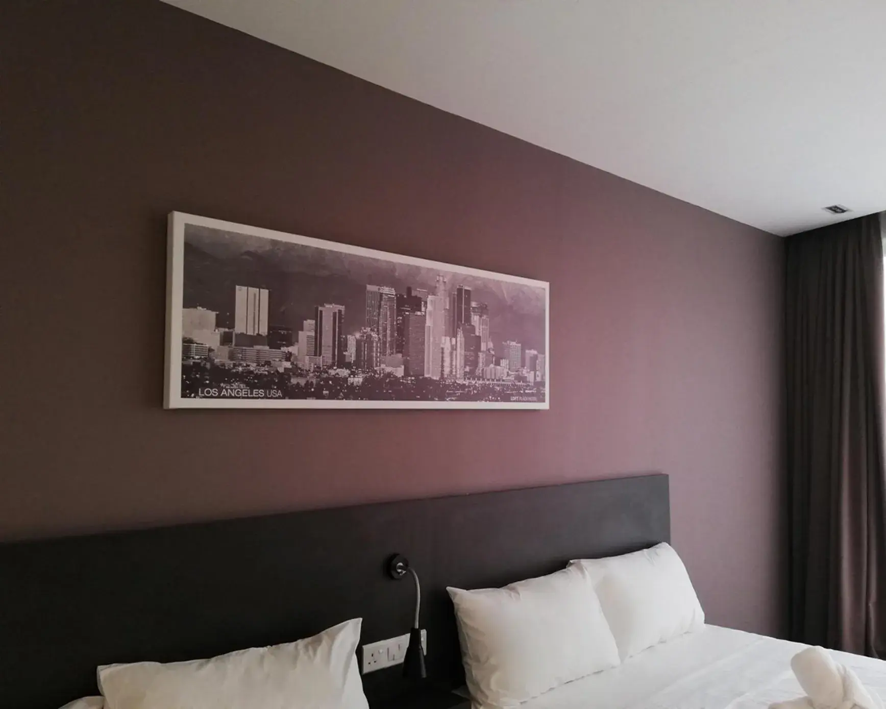 Bed in The Loft Plaza Hotel Bed in The Loft Plaza Hotel