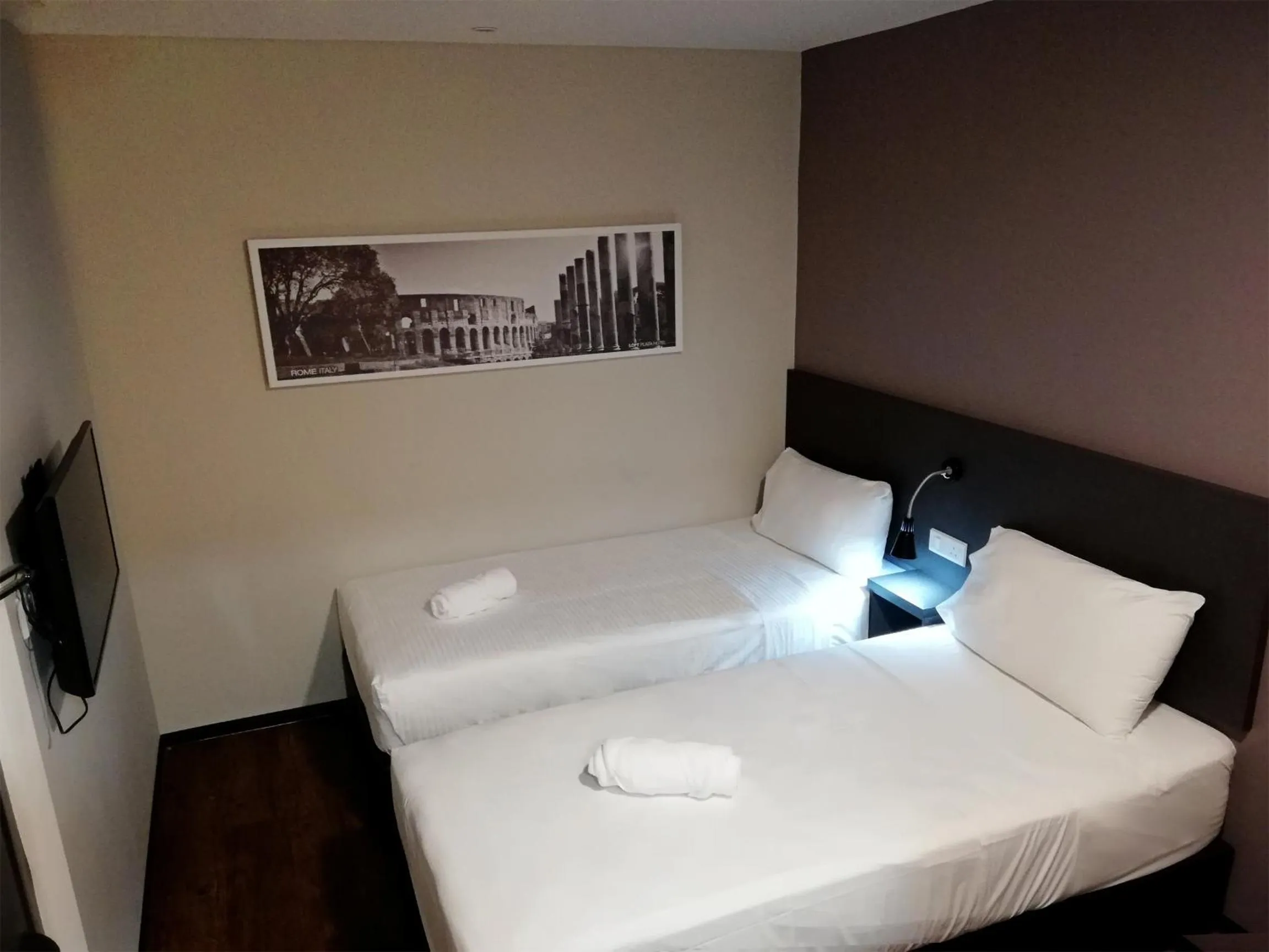 Bed in The Loft Plaza Hotel