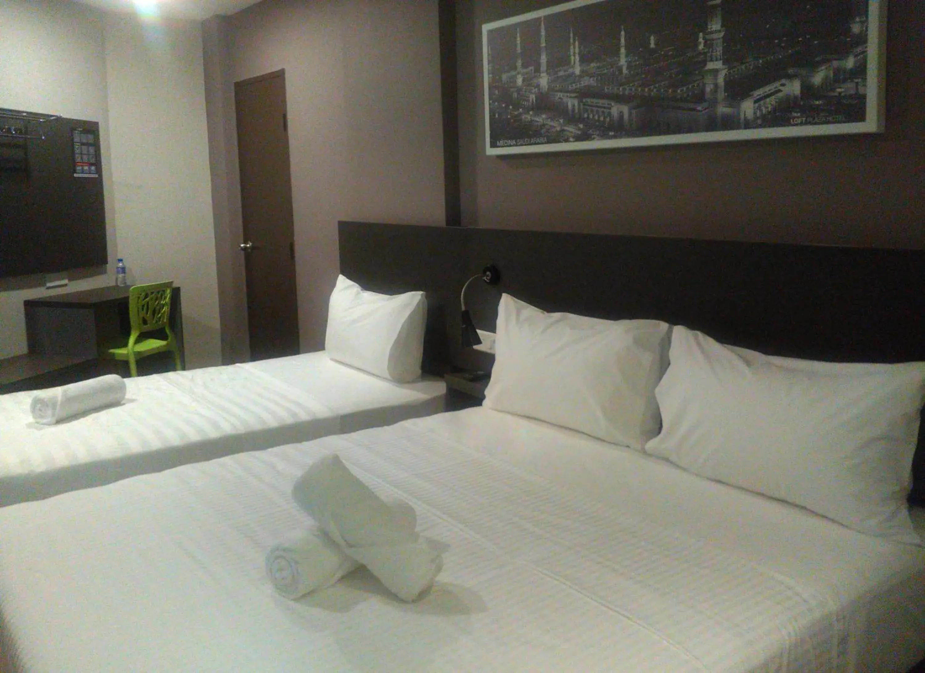 Bed in The Loft Plaza Hotel Bed in The Loft Plaza Hotel