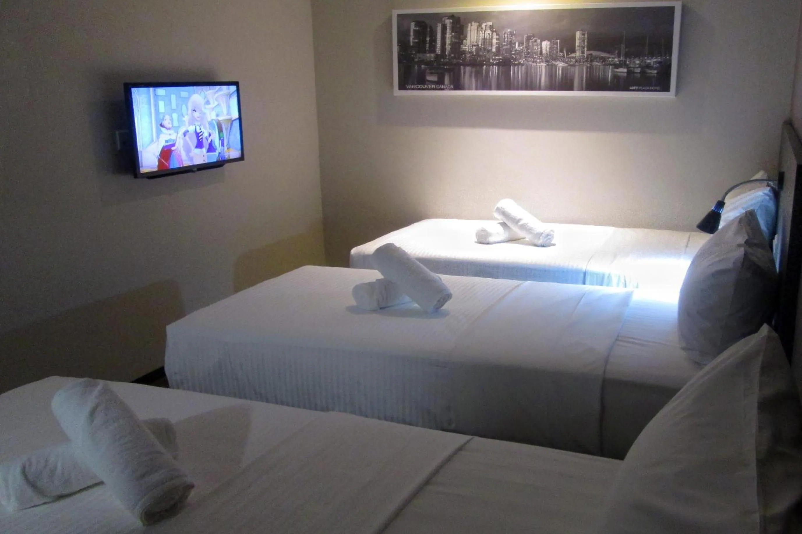 Bed in The Loft Plaza Hotel