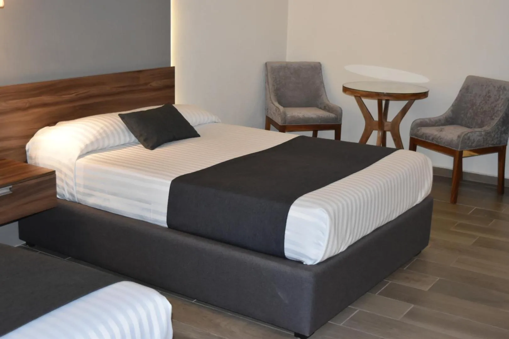 Seating area, Bed in Estanza Hotel & Suites