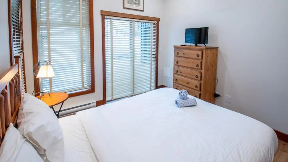 Bed in Snow Creek Lodge by Fernie Lodging Co