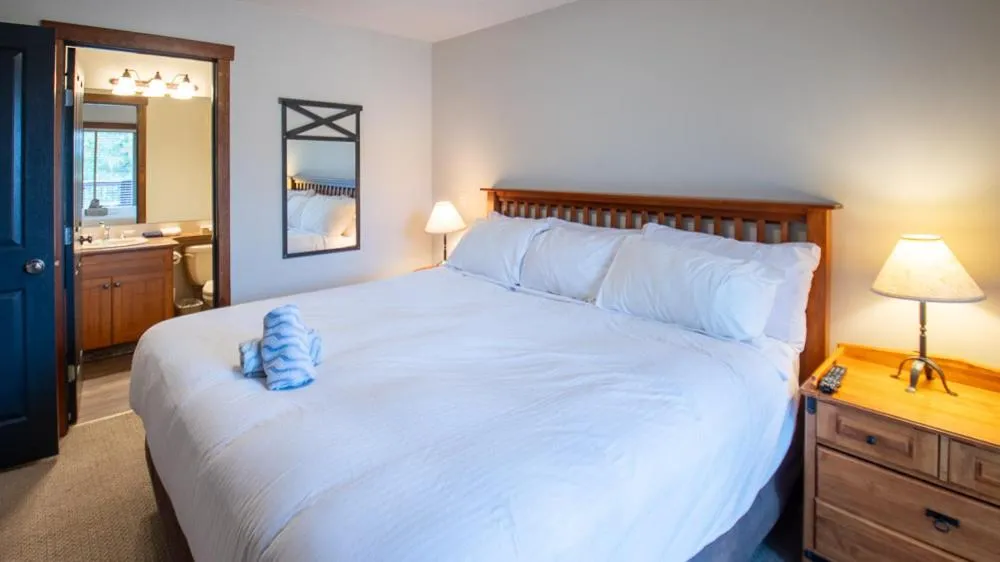 Bed in Snow Creek Lodge by Fernie Lodging Co