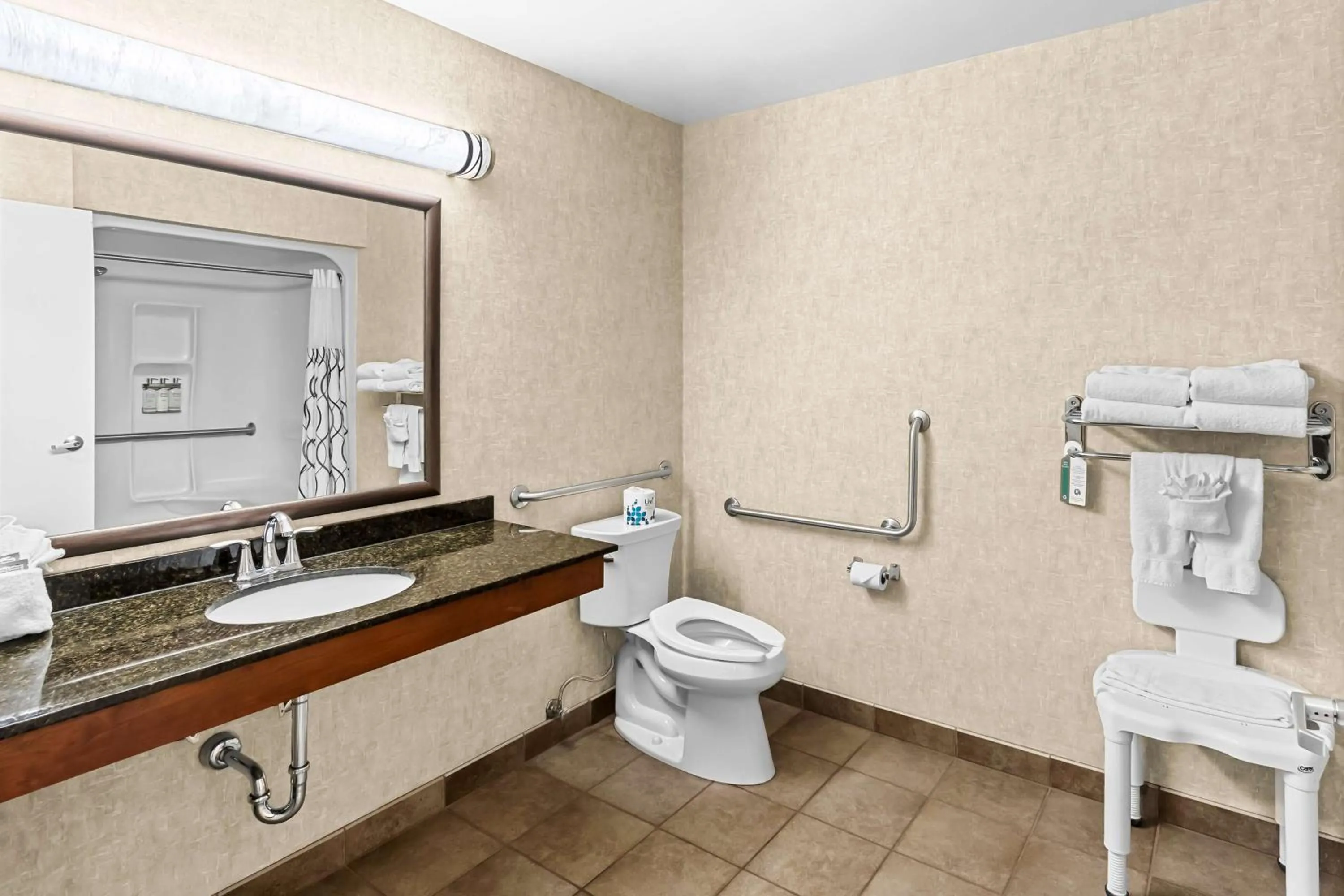 Bedroom in Heartland Inn & Suites, SureStay Collection by Best Western