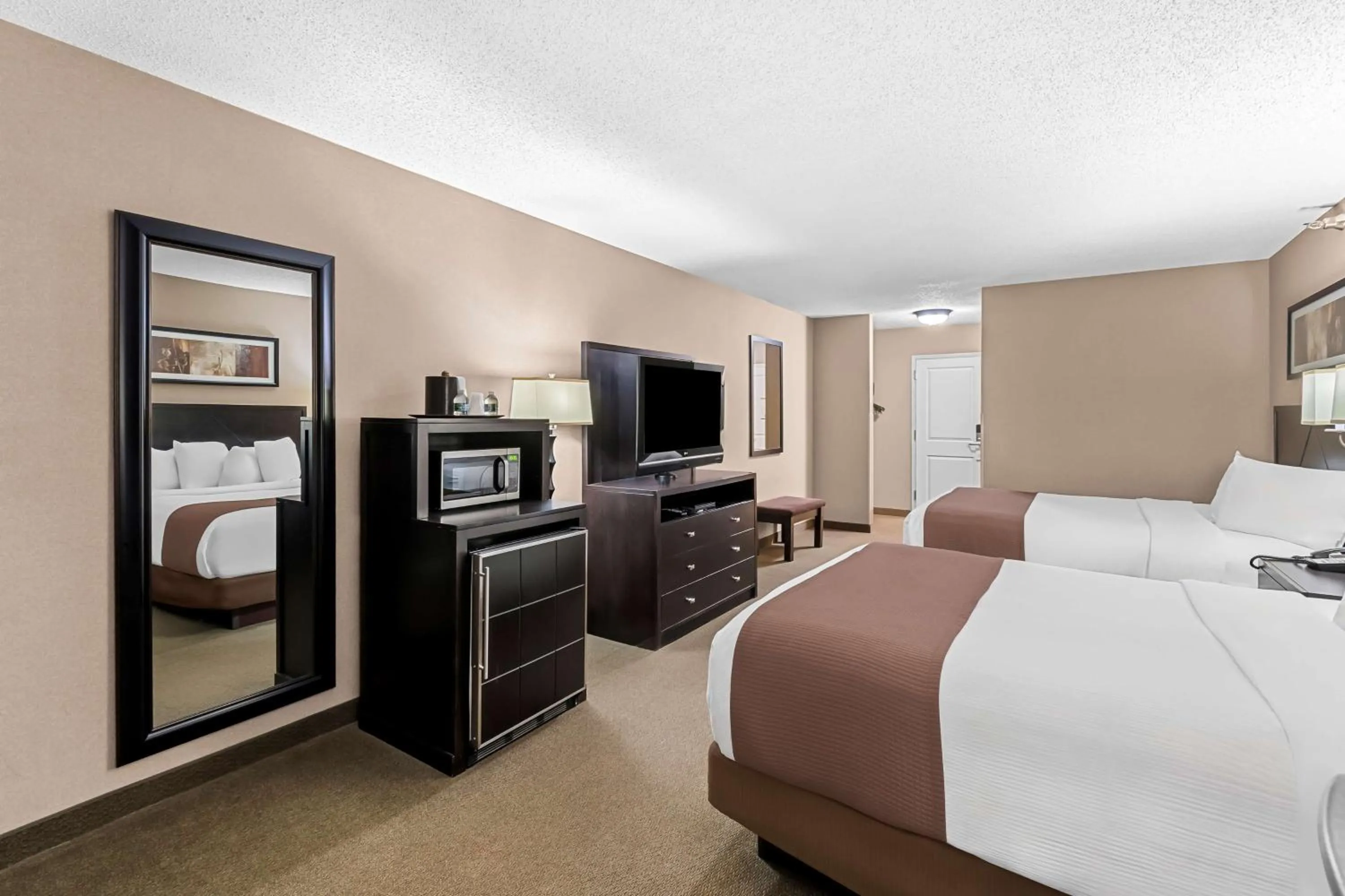 Bedroom, Bed in Heartland Inn & Suites, SureStay Collection by Best Western
