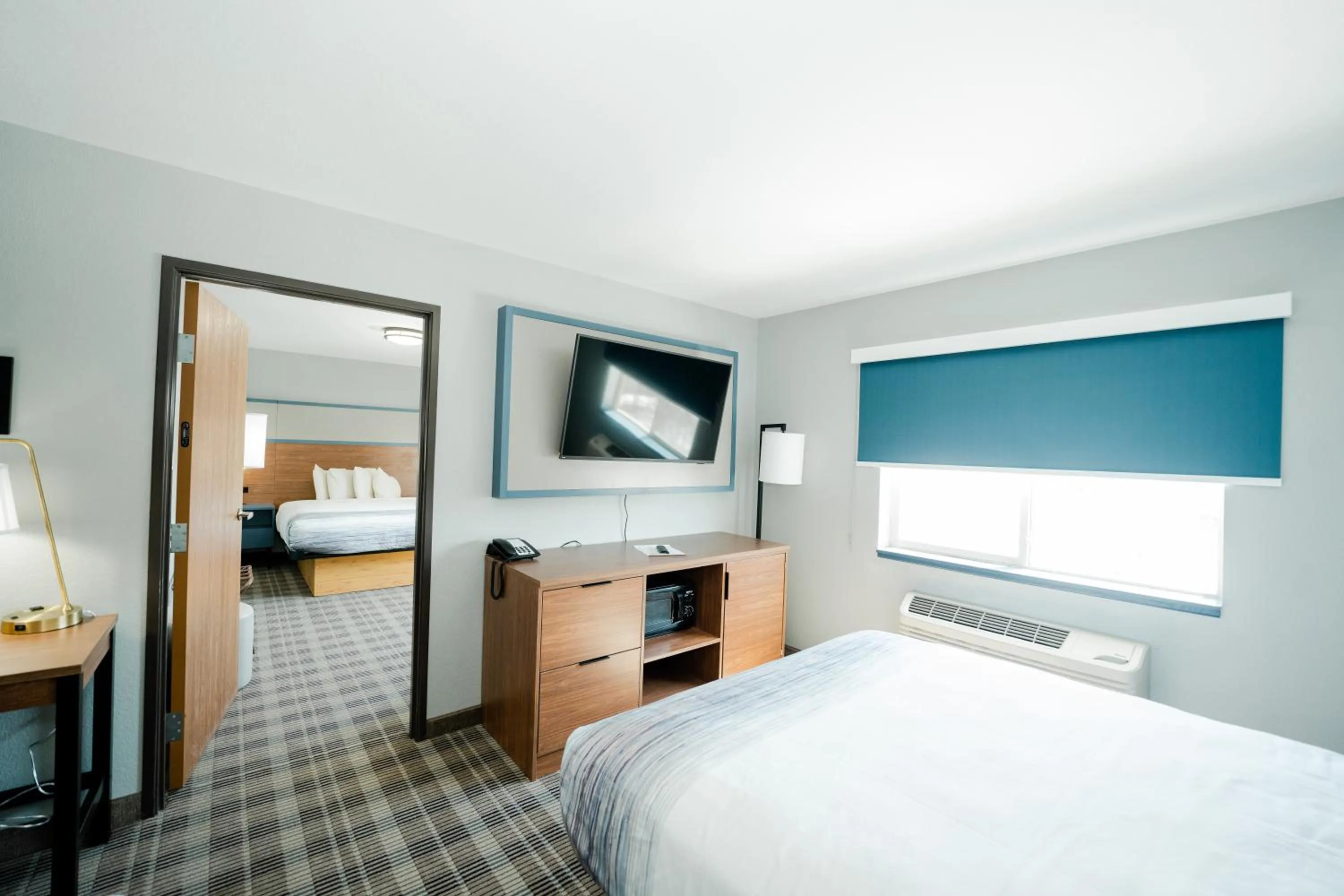 Bed in AmericInn by Wyndham Tomahawk