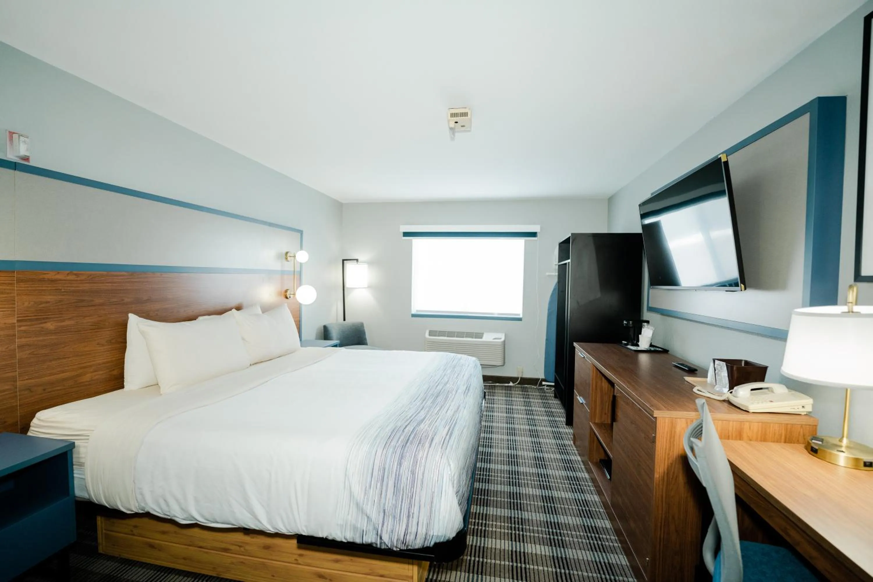 Bed in AmericInn by Wyndham Tomahawk