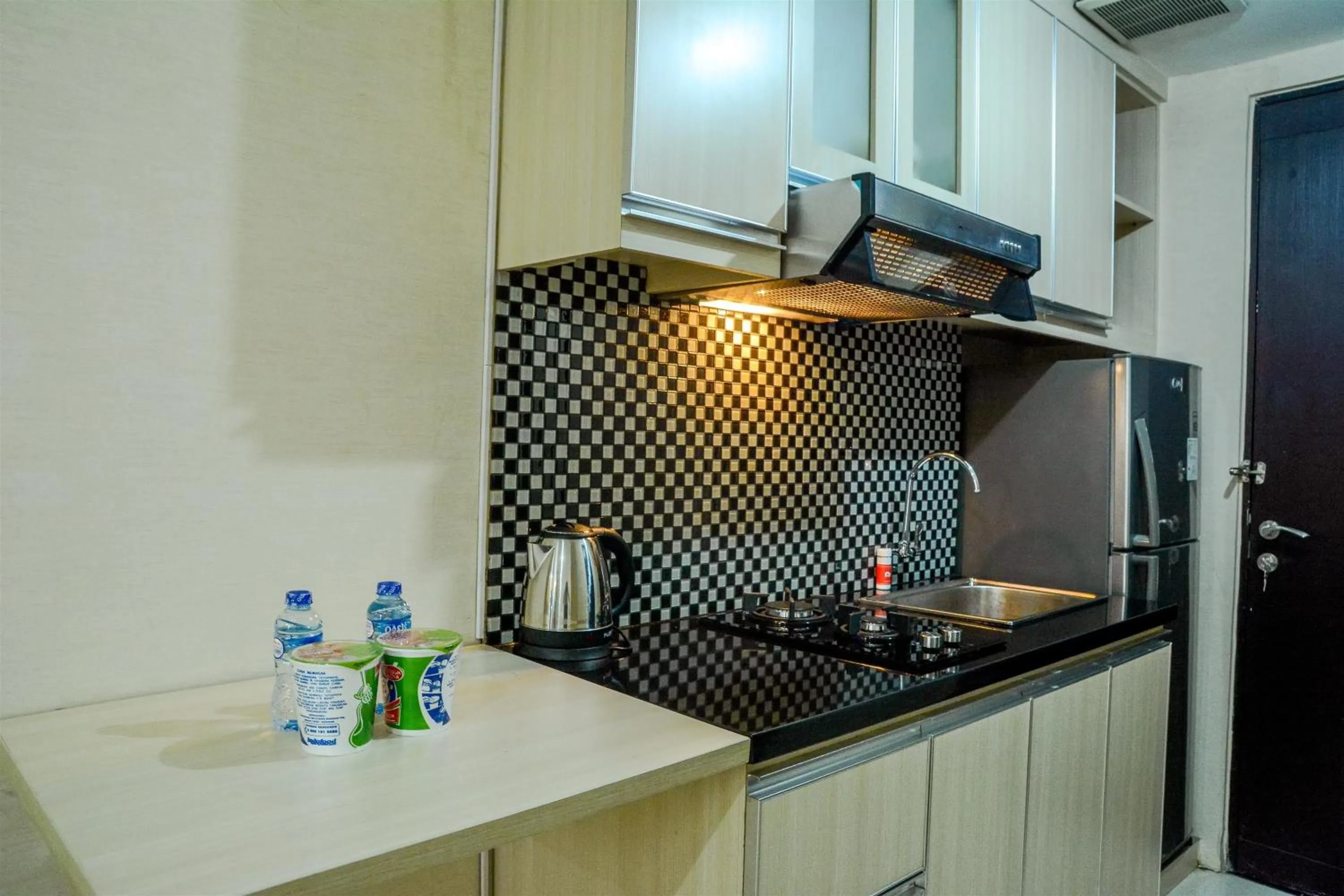 Minimalist Studio Room at Grand Serpong Apartment By Travelio