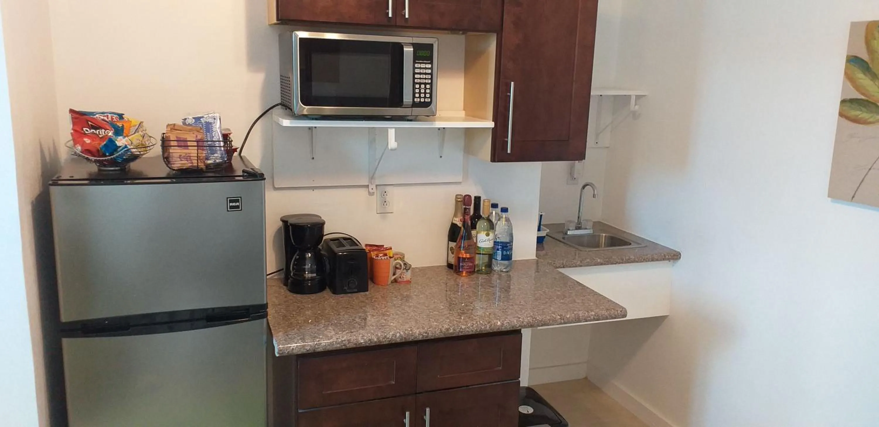 Kitchen or kitchenette in BELL At The Airport Suites Adults Only - Free Airport Transportation