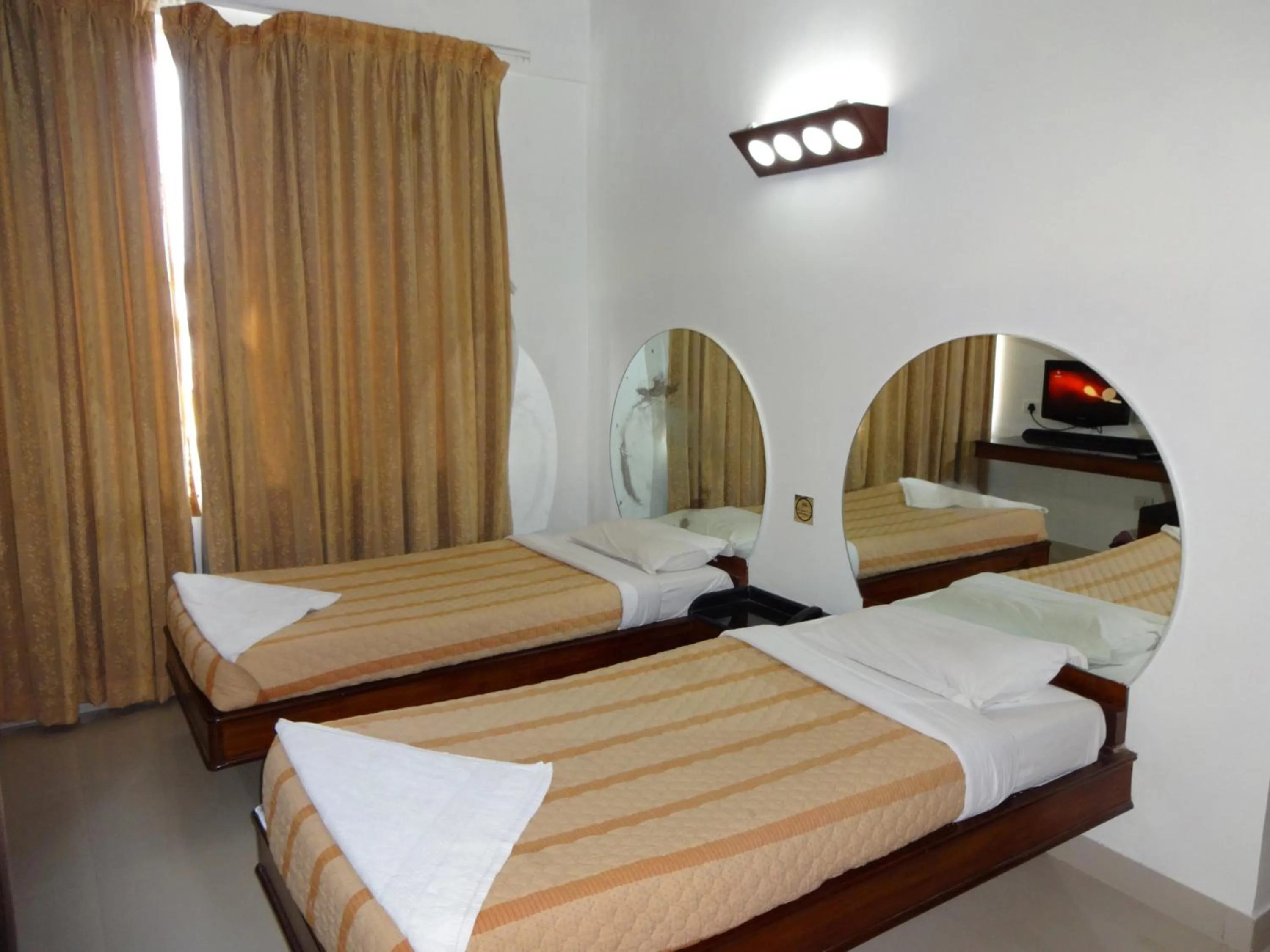 Photo of the whole room, Bed in Lotus Comfort - A Pondy Hotel