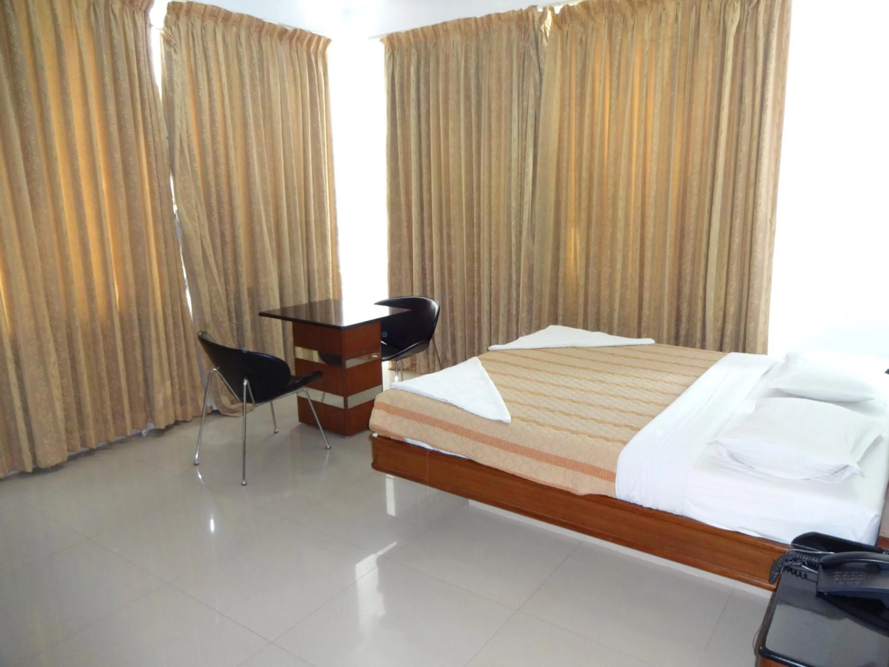 Photo of the whole room, Bed in Lotus Comfort - A Pondy Hotel