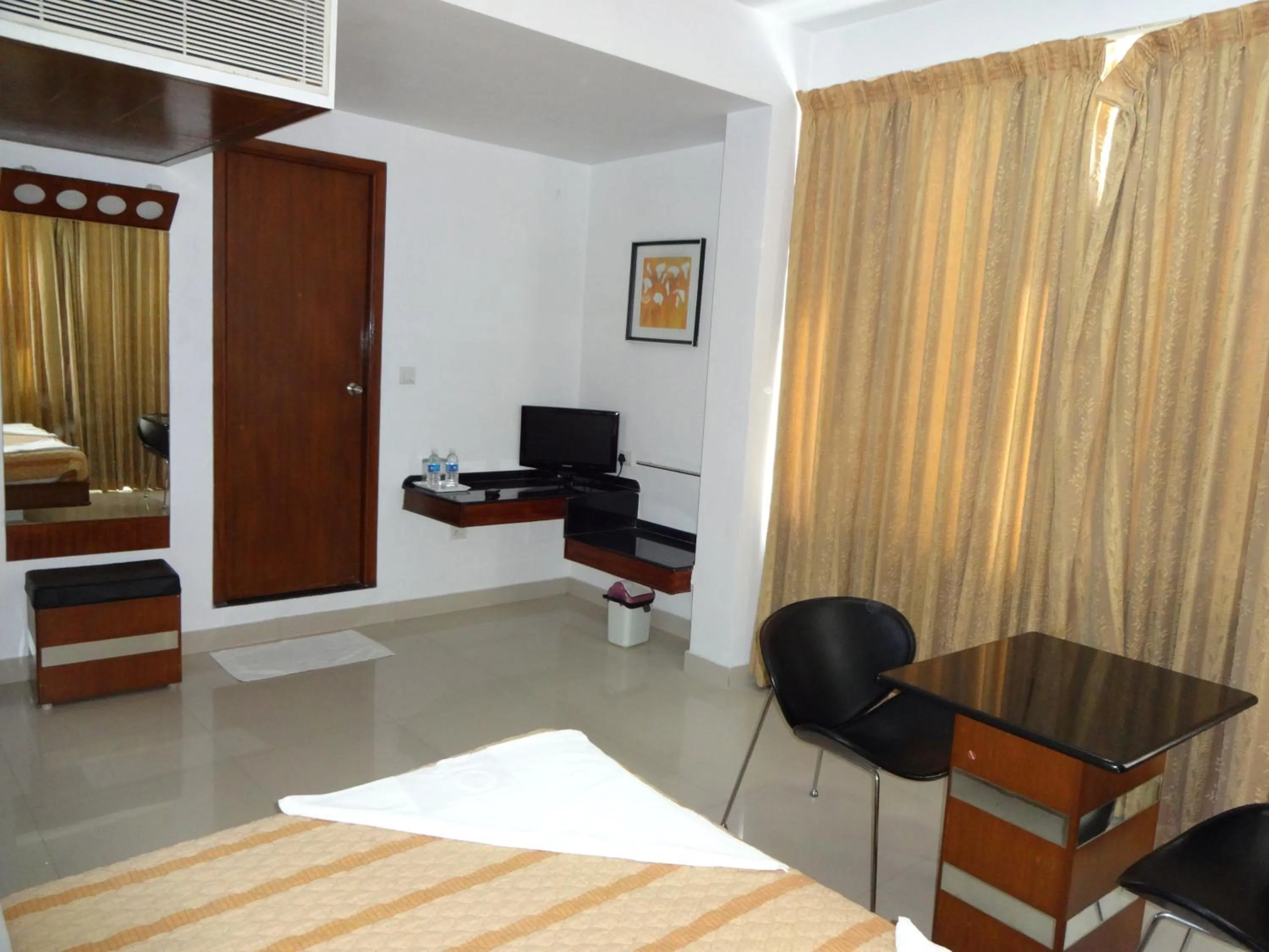 Photo of the whole room, Bed in Lotus Comfort - A Pondy Hotel