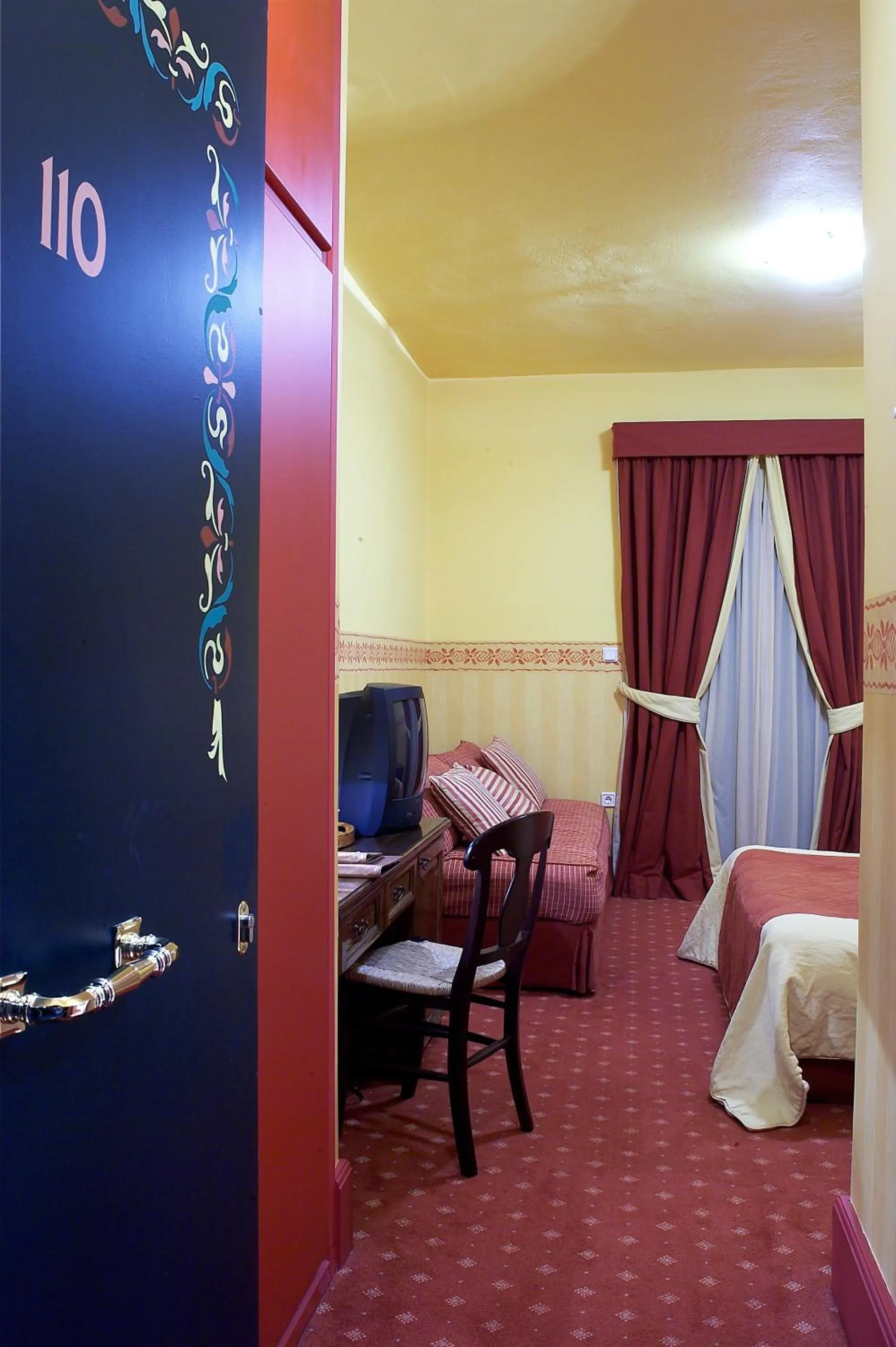 Bed in Country Club Hotel & Suites