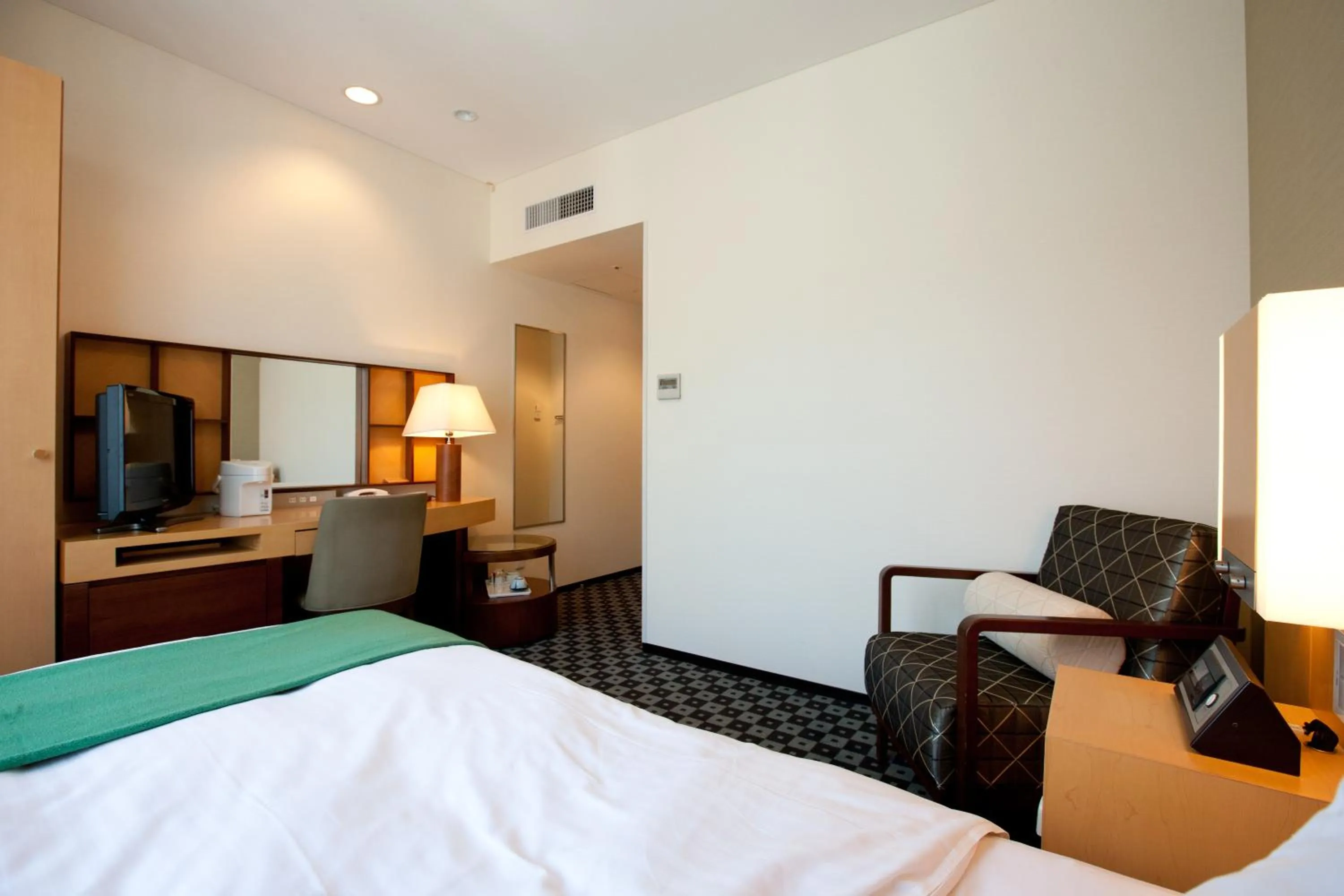 Bed in Hotel Kitano Plaza Rokkoso