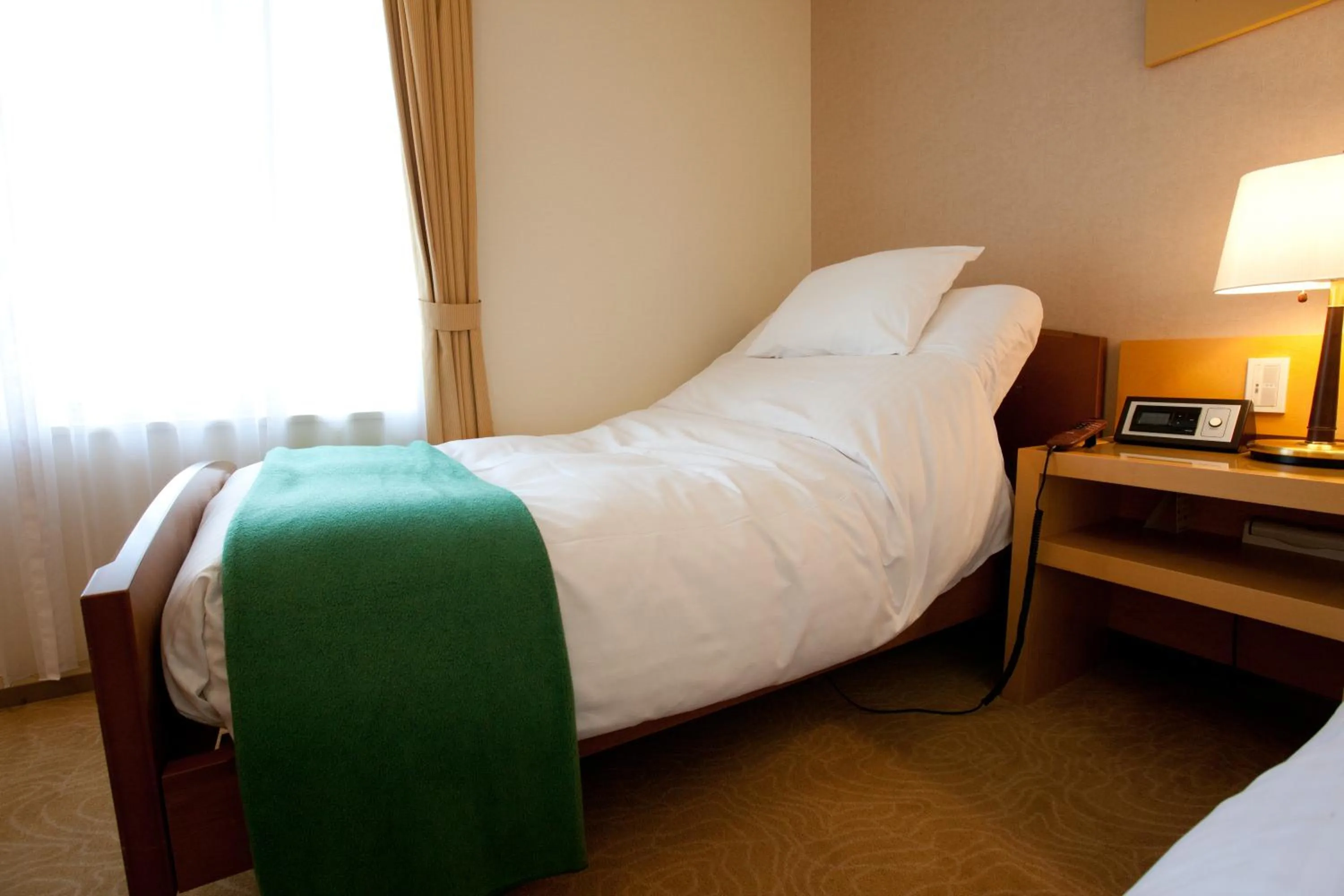 Bed in Hotel Kitano Plaza Rokkoso