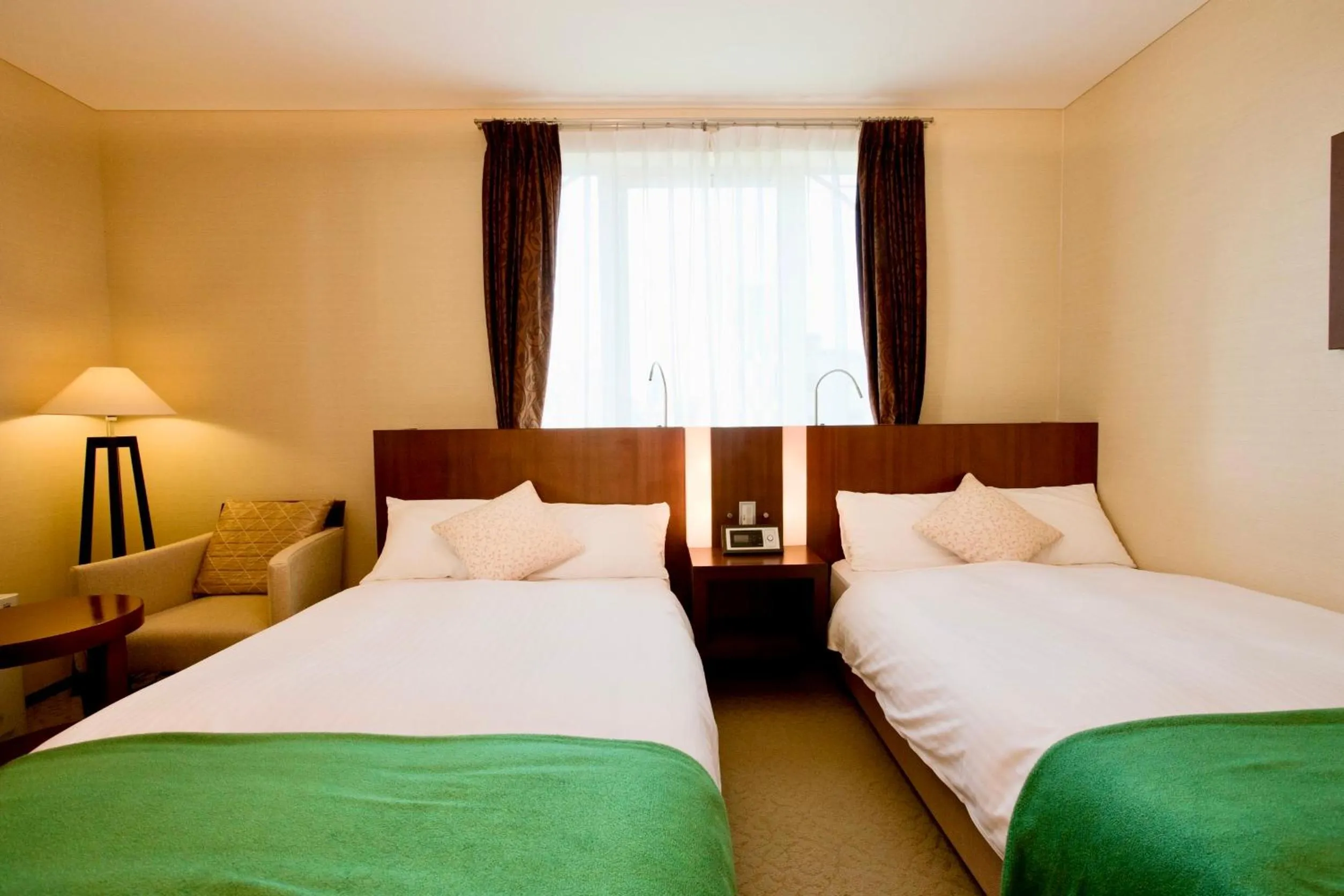 Bed in Hotel Kitano Plaza Rokkoso