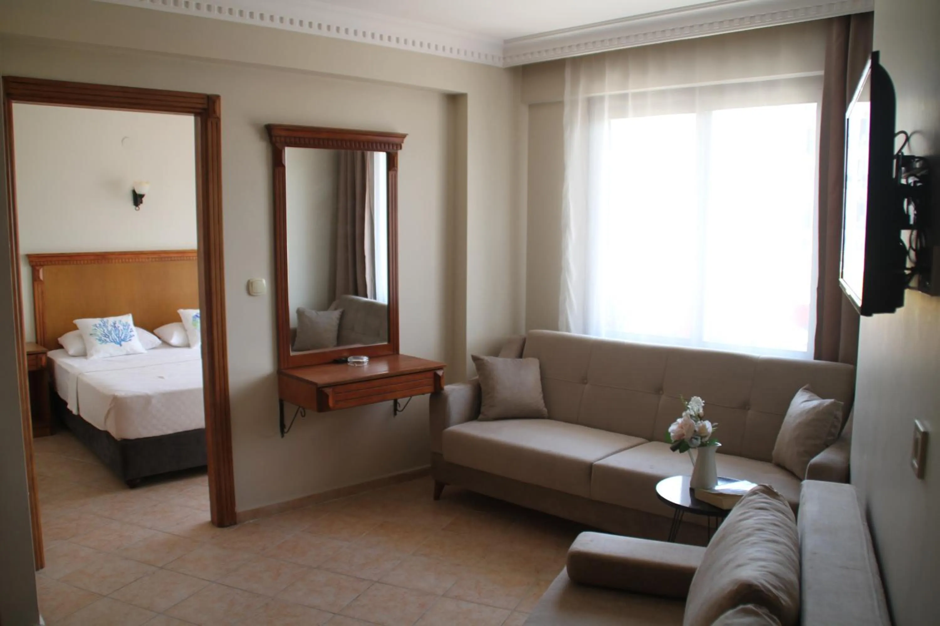Living room, Bed in Rosy Suites Hotel