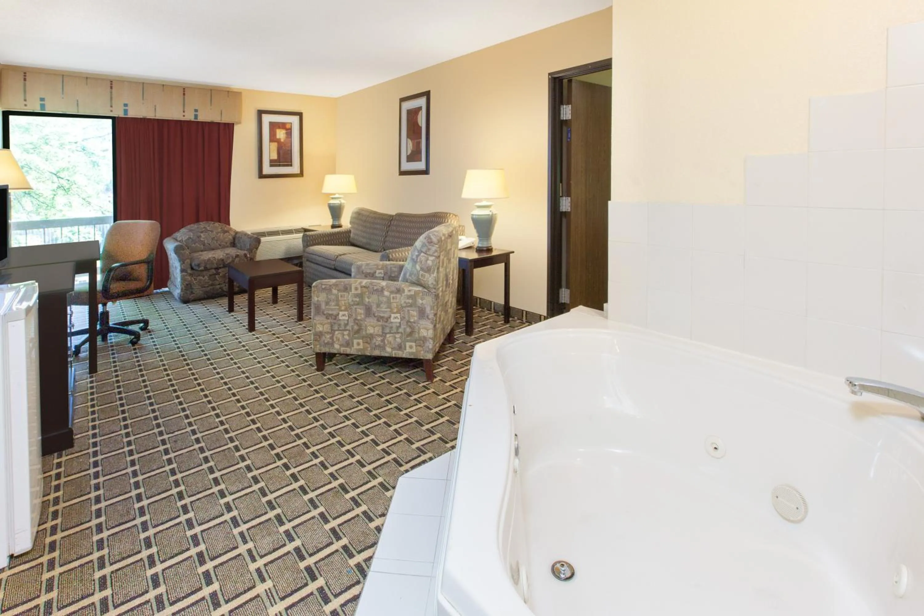 Bathroom, Bed in Days Inn & Suites by Wyndham Madison Heights MI