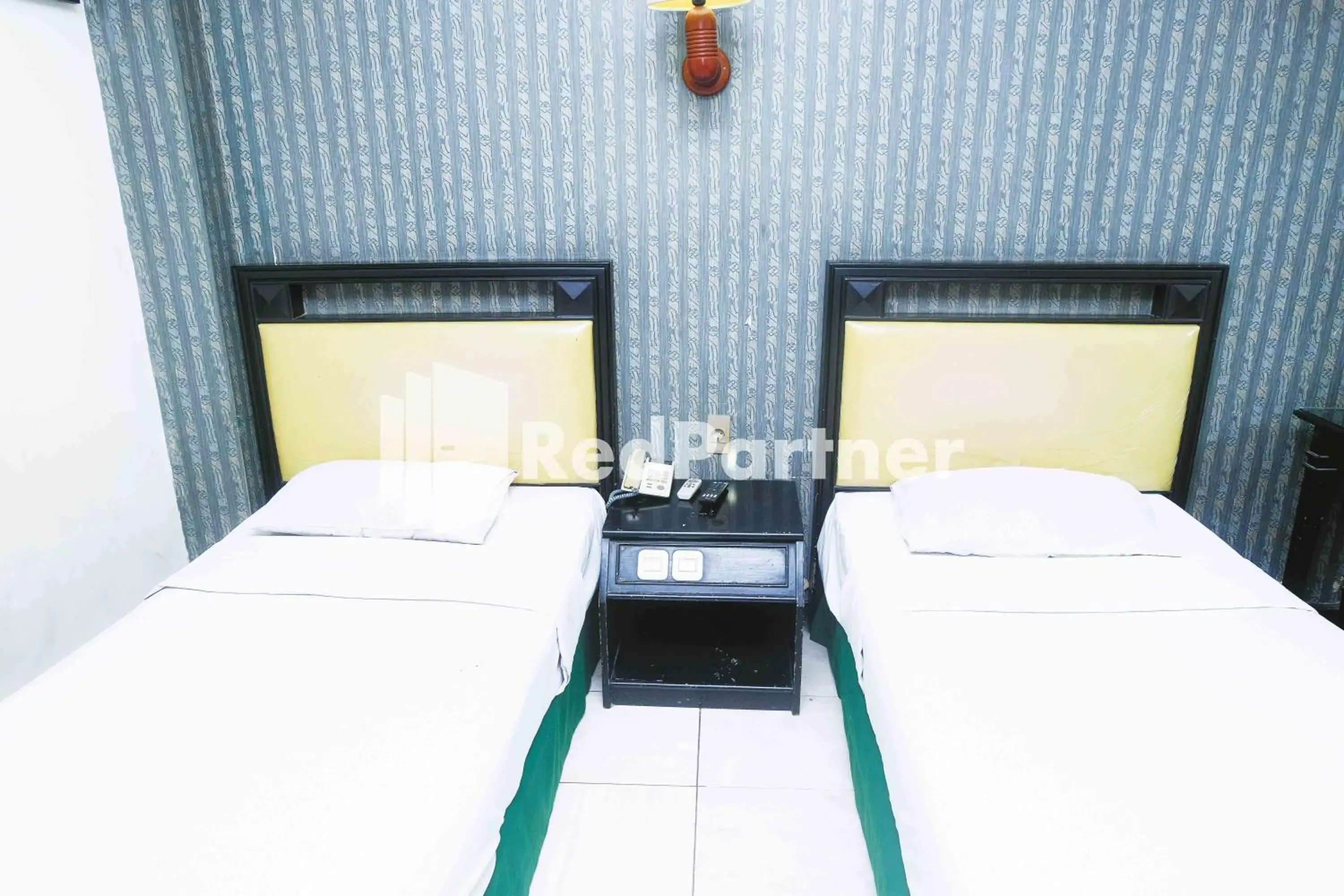 Bed in Hotel Yasmin Makassar RedPartner