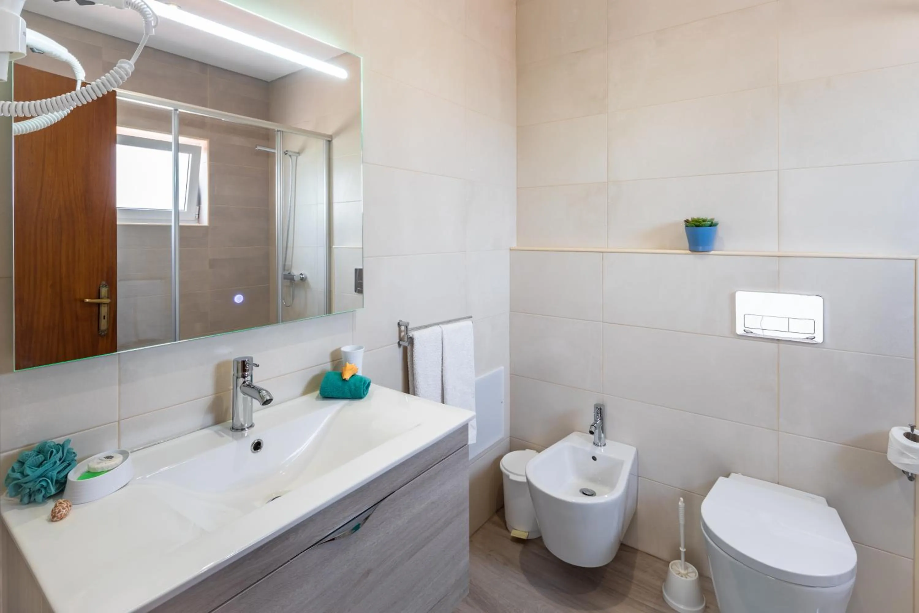 Bathroom in Apartamentos Flor da Laranja, Albufeira by AlgarveBlossom