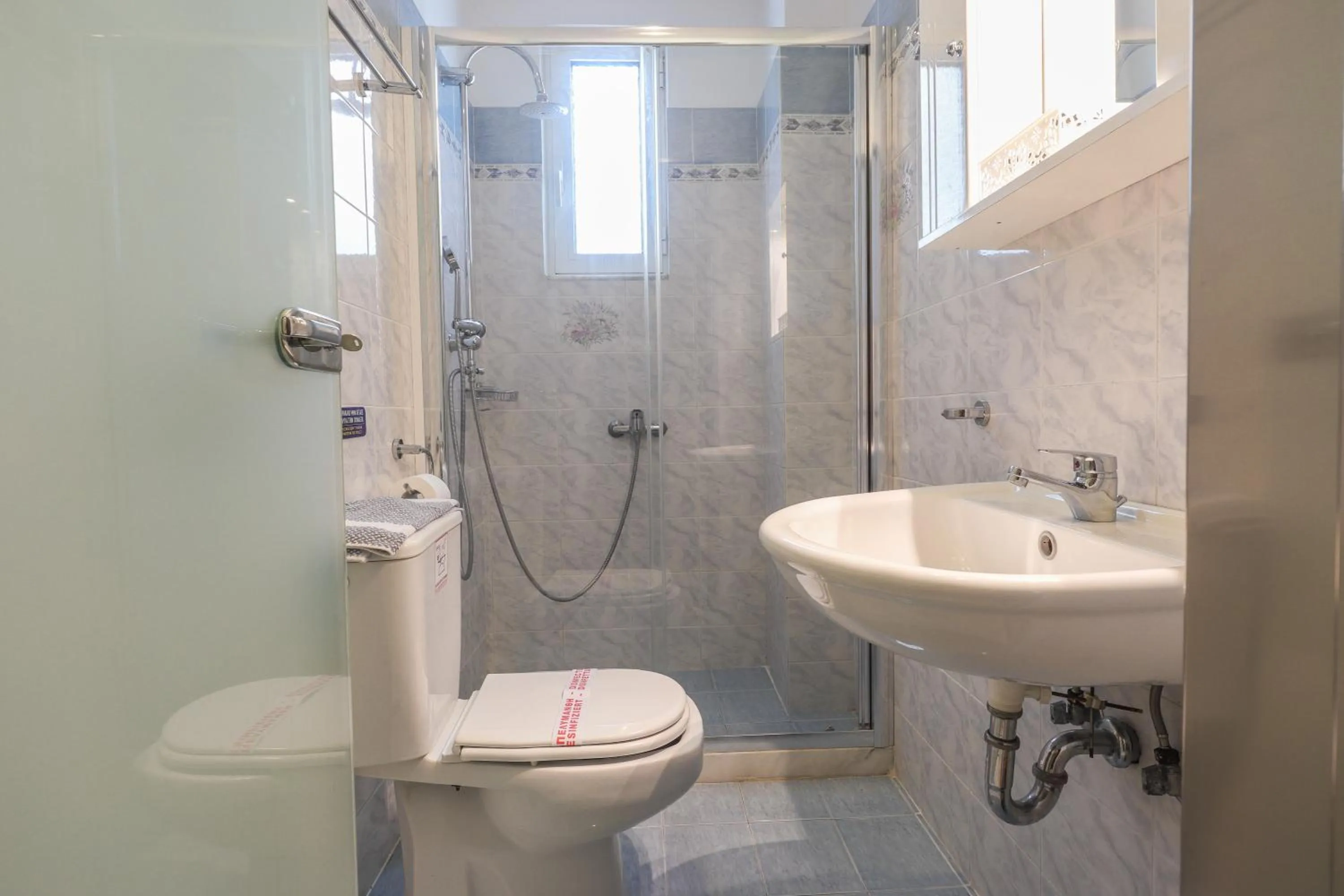 Bathroom in Delfini Beach Hotel & Suites